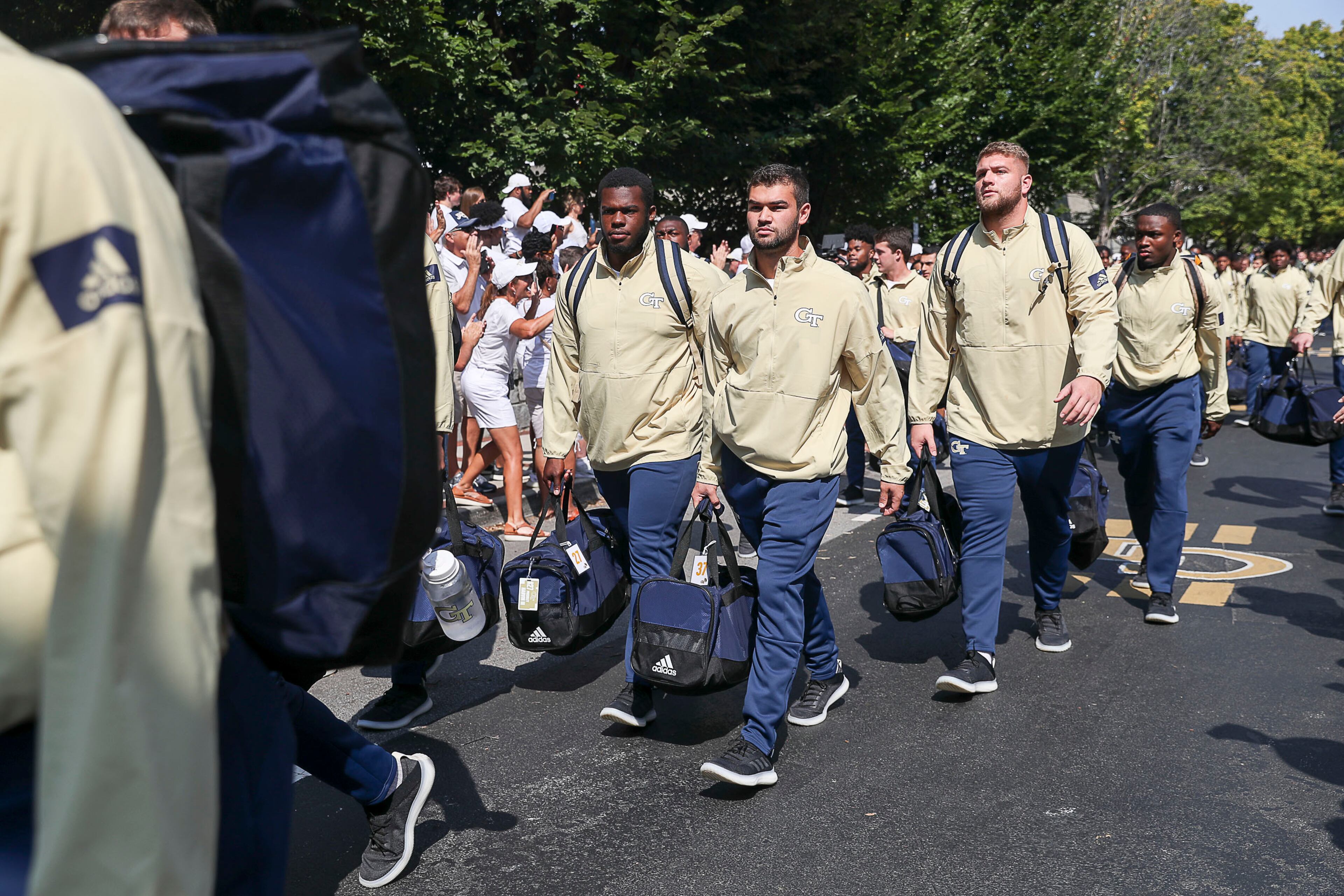 Members of the Georgia Tech Yellow Jackets football team are cheered on before the home opener. (Alyssa Pointer/alyssa.pointer@ajc.com)