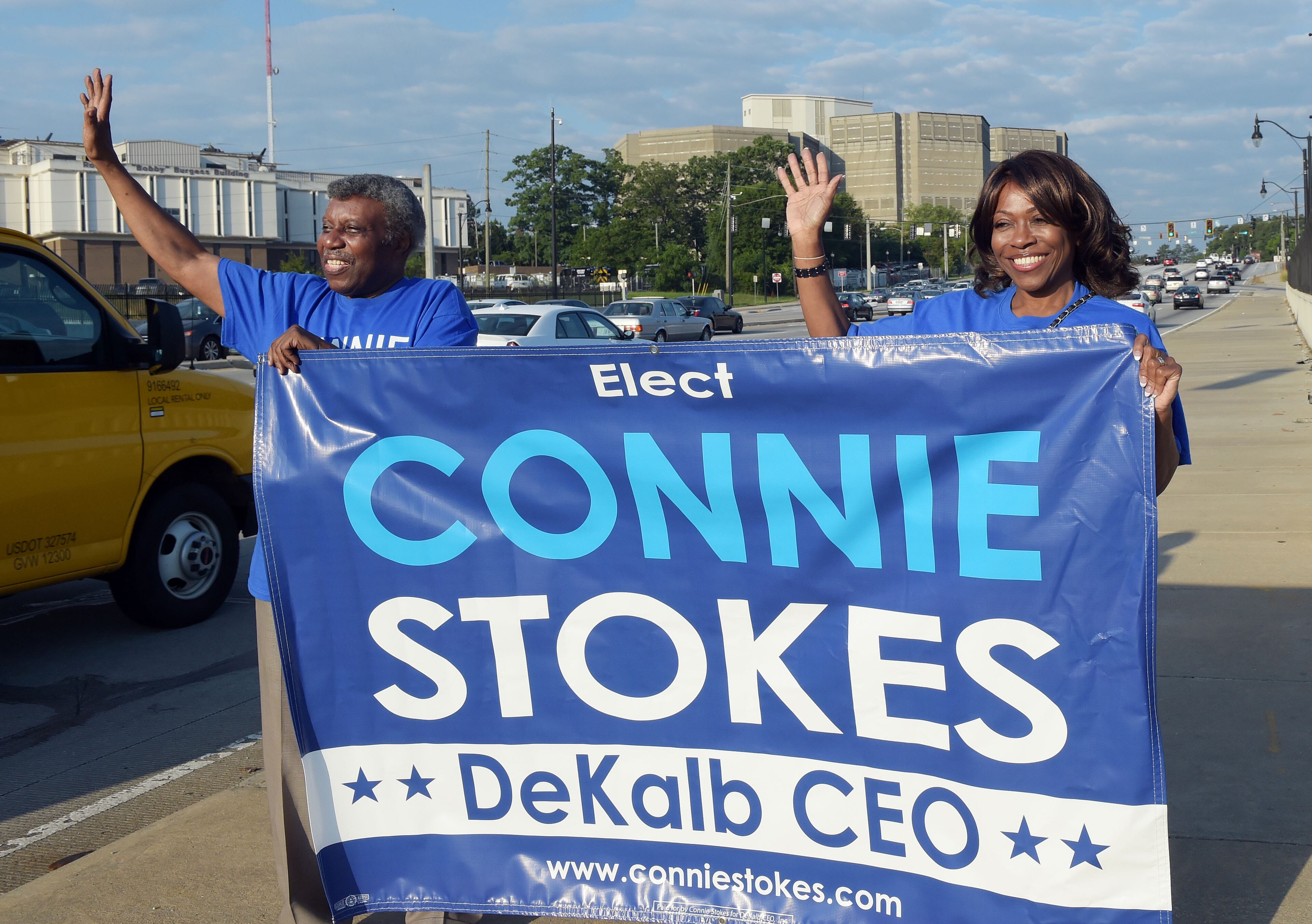DeKalb CEO candidate Connie Stokes waves at traffic with her husband, Dr James Stokes at the intersection of Memorial Drive and I-285, Tuesday morning. DeKalb County voters go to the polls on primary election day Tuesday, May 24, 2016. The DeKalb CEO, District attorney and several other races are on the ballot, as well as an extension of the DeKalb schools E-Splost.