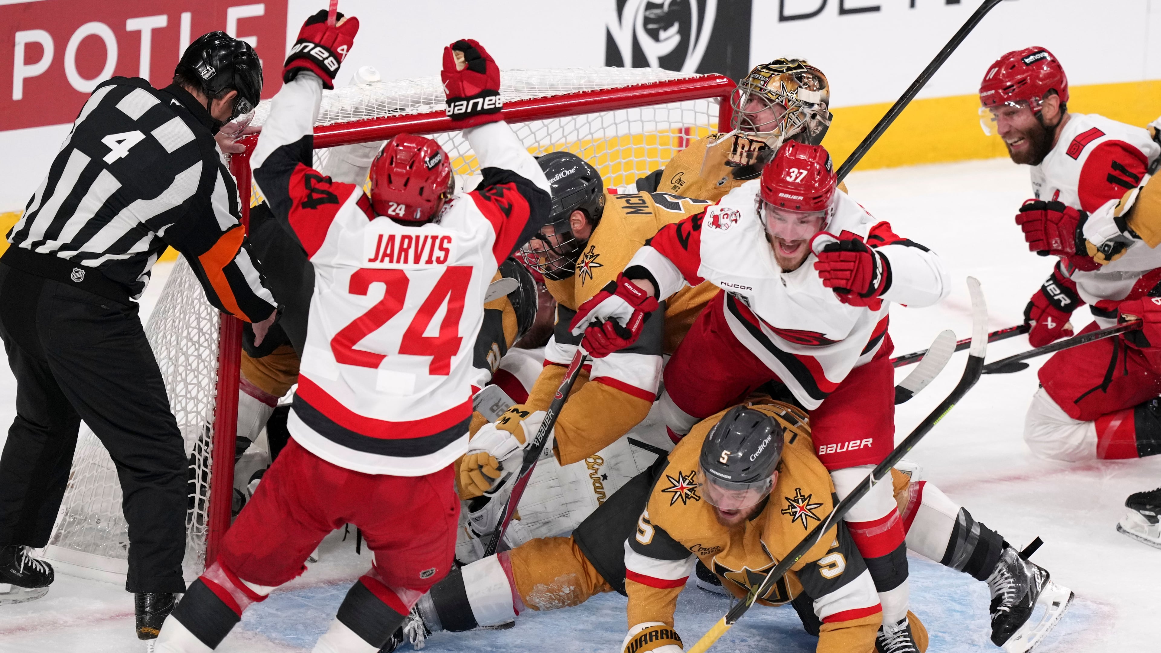 Carolina Hurricanes right wing Andrei Svechnikov (37) celebrates his goal with right wing Seth Jarvis (24) and center Jordan Staal (11) as he steps over Vegas Golden Knights defenseman Jeremy Lauzon (5) during the third period in Game 3 of the NHL hockey Stanley Cup Final series Saturday, June 6, 2026, in Las Vegas. (AP Photo/Candice Ward)