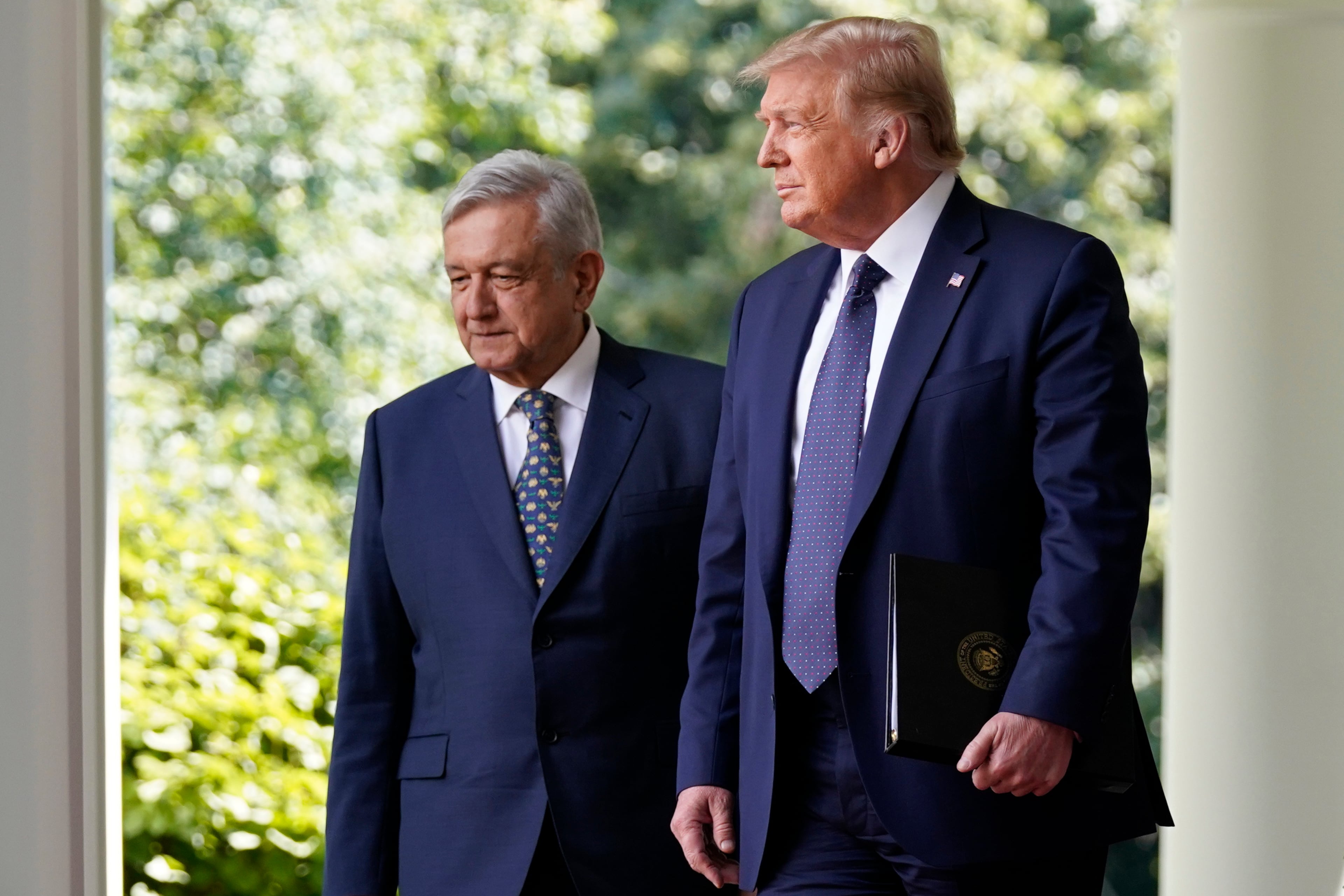 President Donald Trump and Mexican President Andres Manuel Lopez Obrador arrive for an event in the Rose Garden.