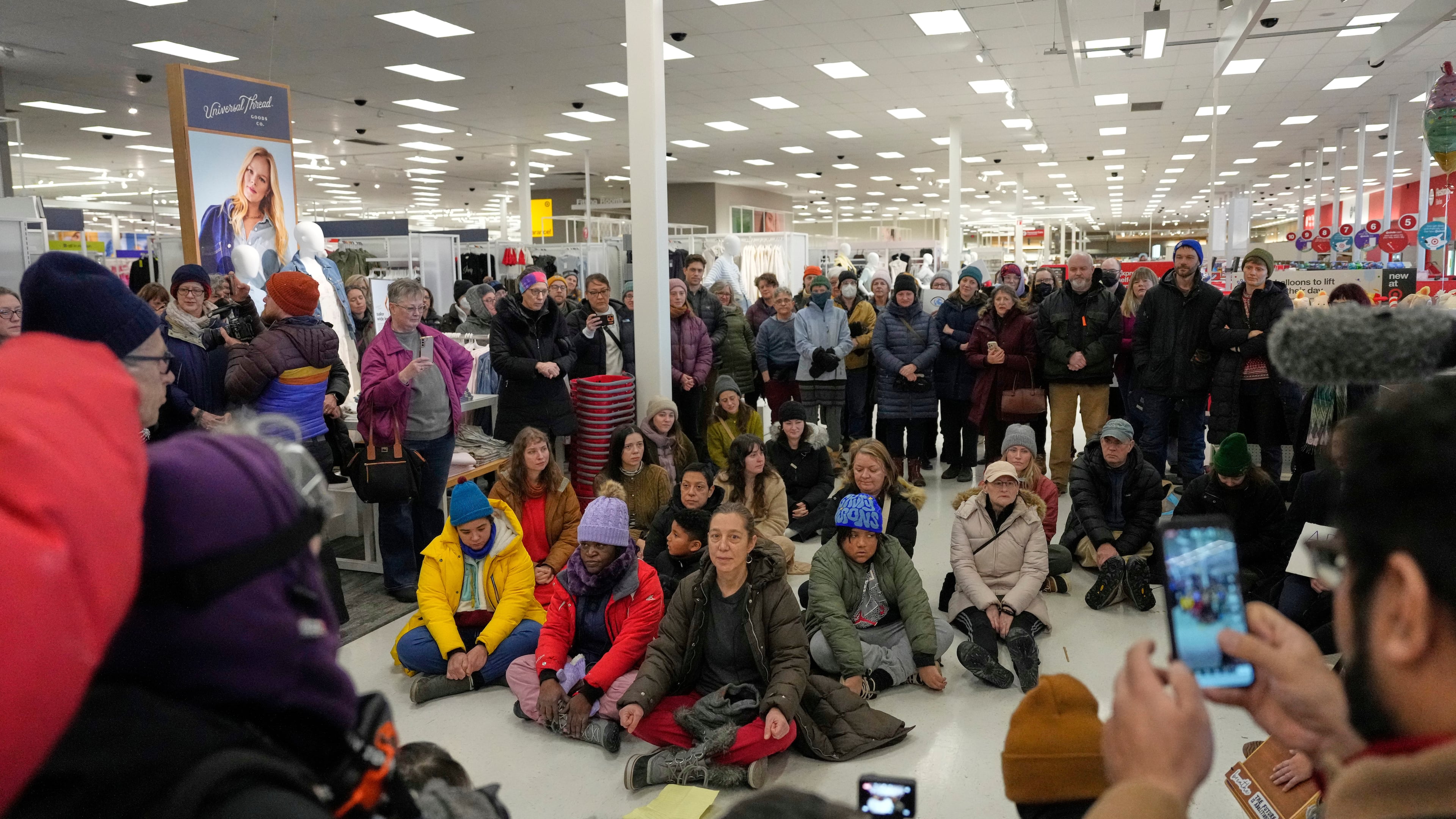 Community members and neighbors of people detained by ICE gather in protest at a Target store, Monday, Jan. 19, 2026, in St. Paul, Minn. (AP Photo/Yuki Iwamura)