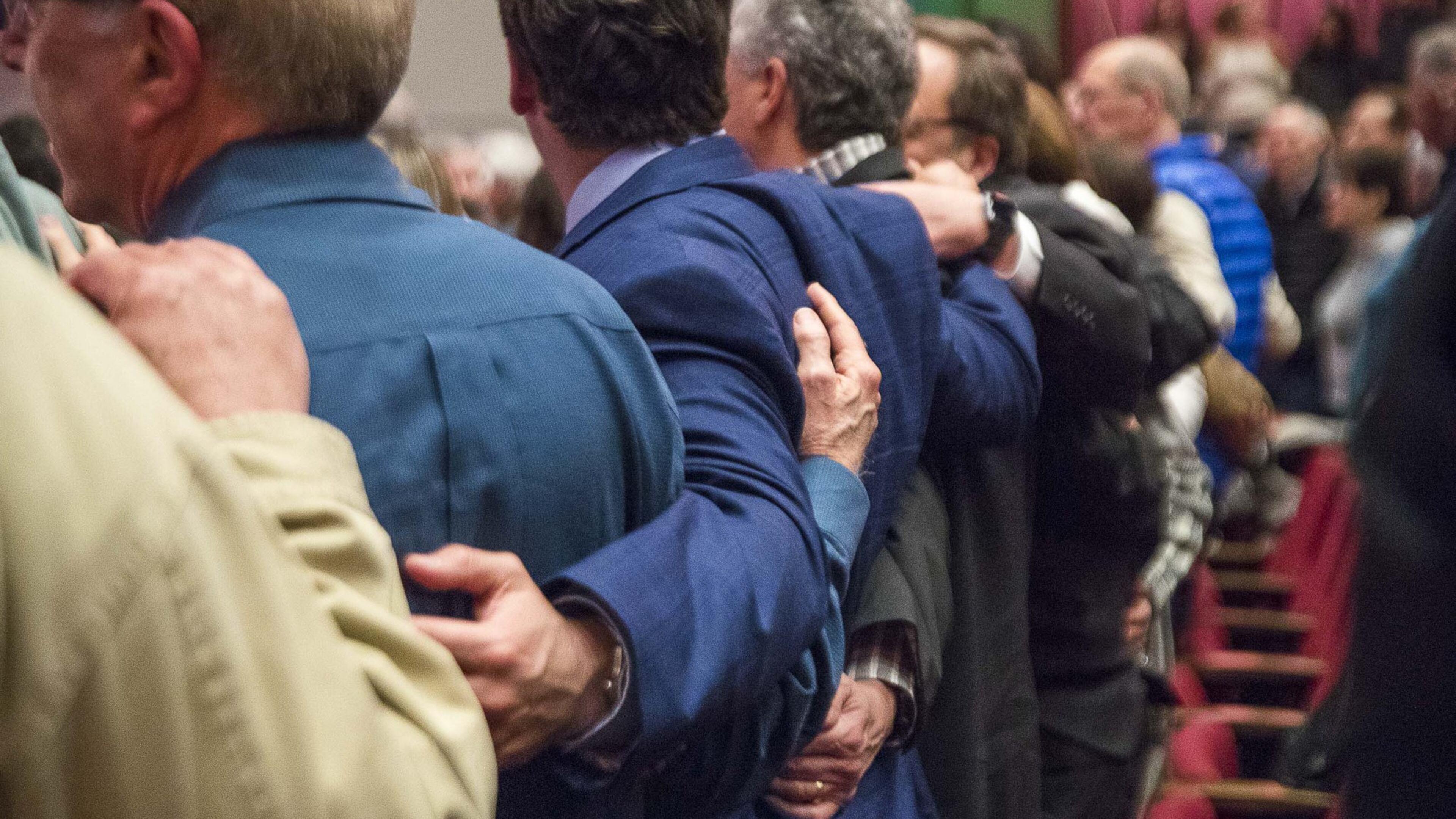 Supporters of a Jewish solidarity event embrace as they sing a song Jan. 6 at Byers Theatre in Sandy Springs. This event was held in response to the recent hate attacks in New York and New Jersey. ALYSSA POINTER / ALYSSA.POINTER@AJC.COM