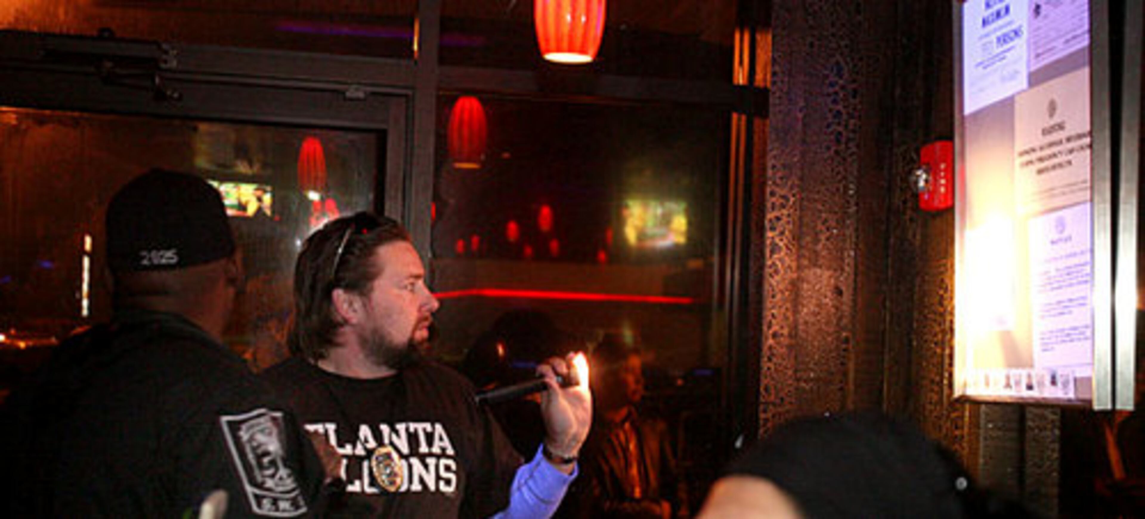 Detective J. Conley (left) and Sgt. A.T. Mears check posted permits when they arrive at El Noa Noa on Saturday. The club did not have its liquor or business license posted, so it was quickly shut down.