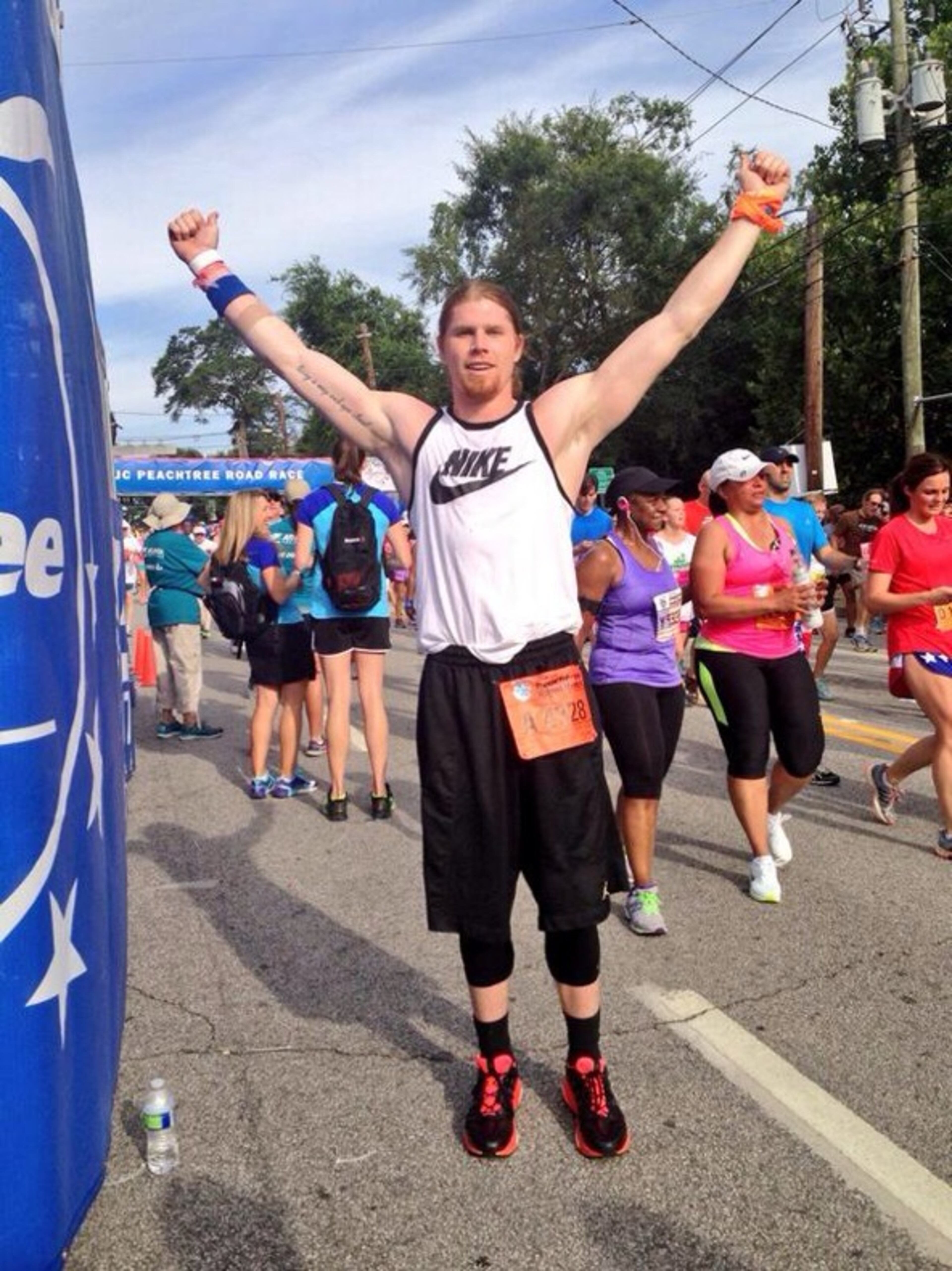 Less than 24 hours after donating 1.5 liters of bone marrow to his father, TNT sideline reporter Craig Sager Sr., Craig Sager Jr. boarded MARTA to get to the starting line of The Atlanta Journal-Constitution Peachtree Road Race. (Photo by Erica A. Hernandez/AJC)