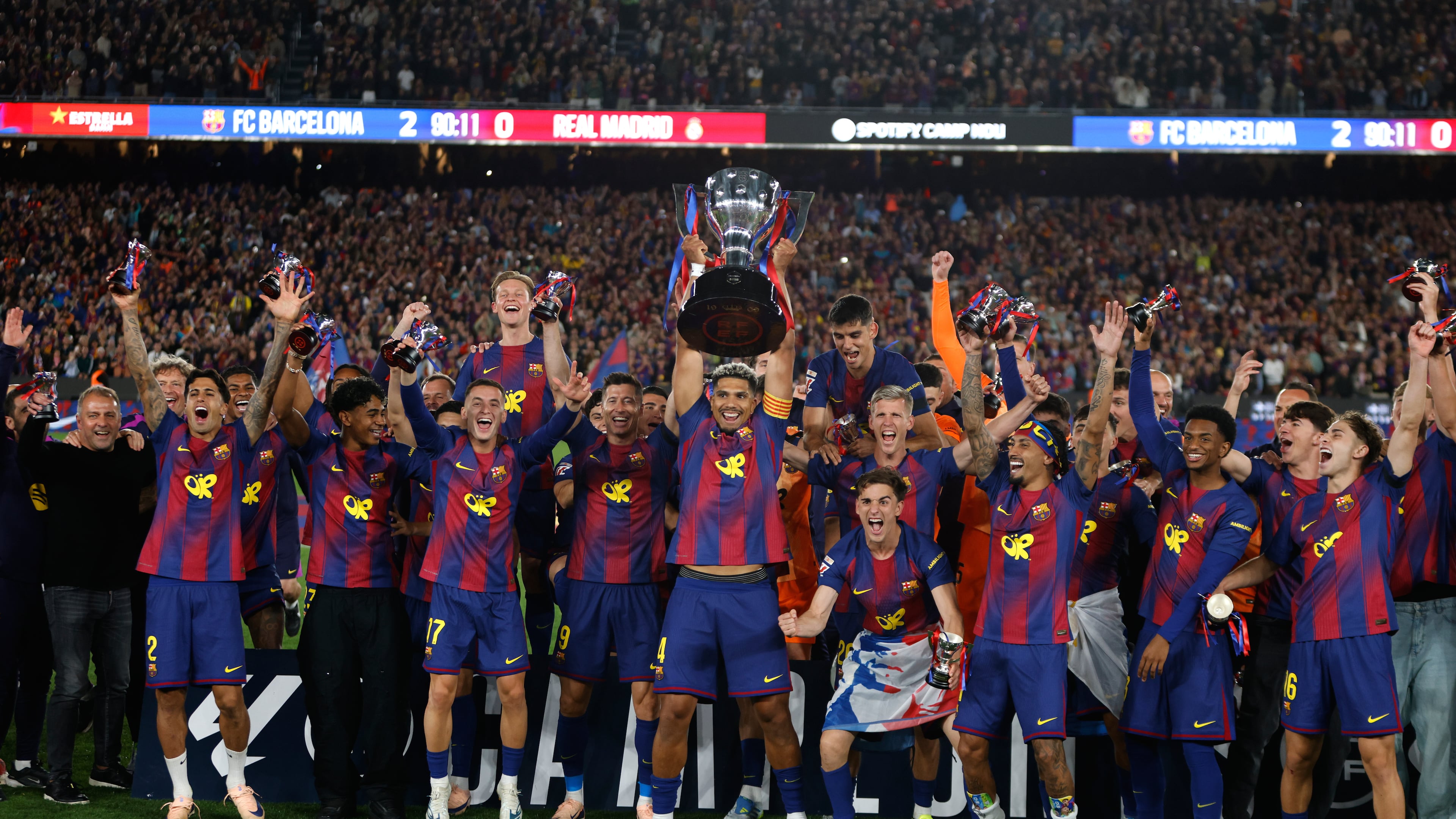 Barcelona players lift the trophy after winning the Spanish La Liga soccer match against Real Madrid to clinch the Spanish league title in Barcelona, Spain, Sunday, May 10, 2026. (AP Photo/Joan Monfort)