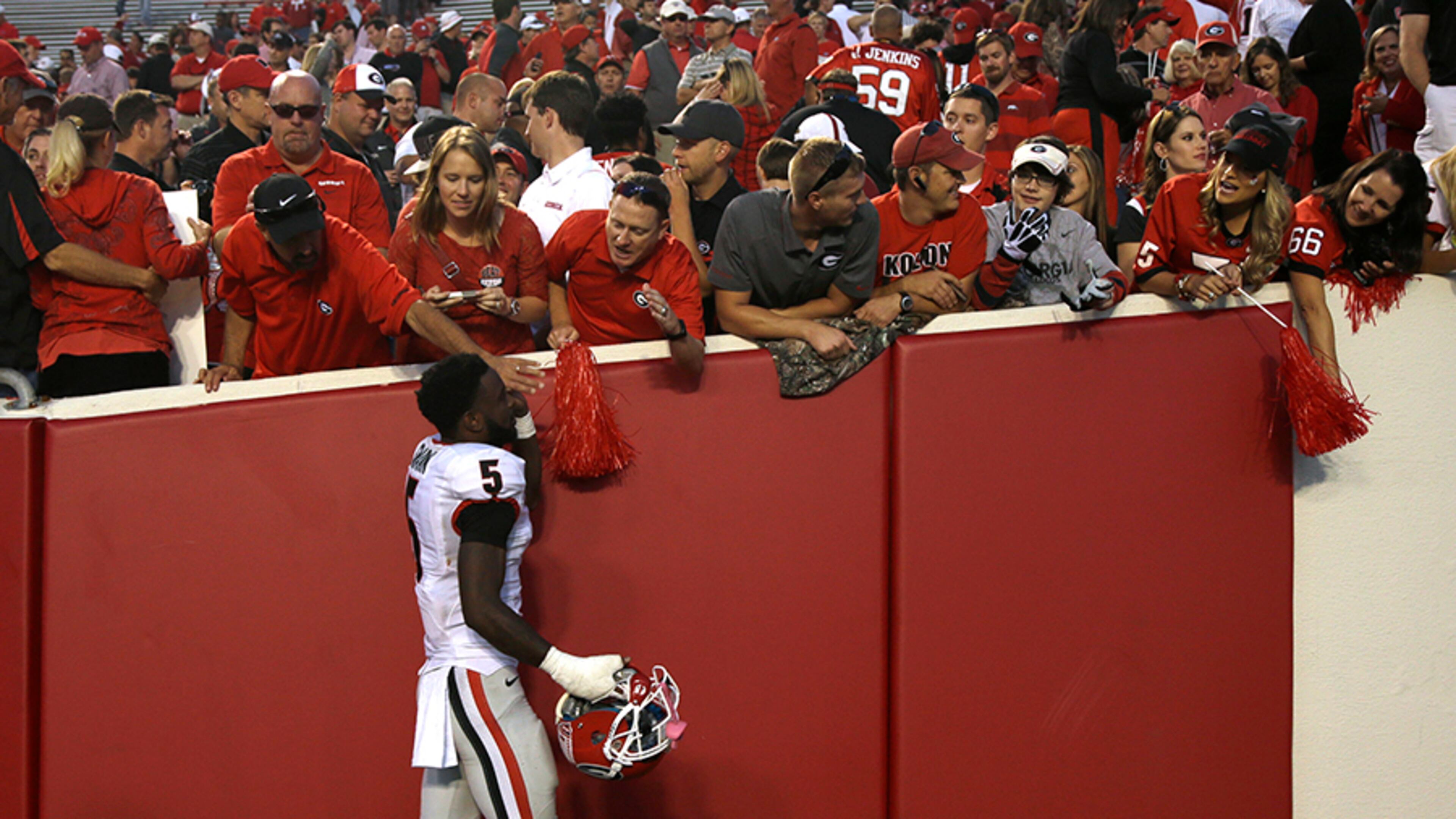 Cornerback Damian Swann celebrates with Georgia fans after the 45-32 win over Arkansas at Little Rock, Ark., Saturday, Oct. 18, 2014.