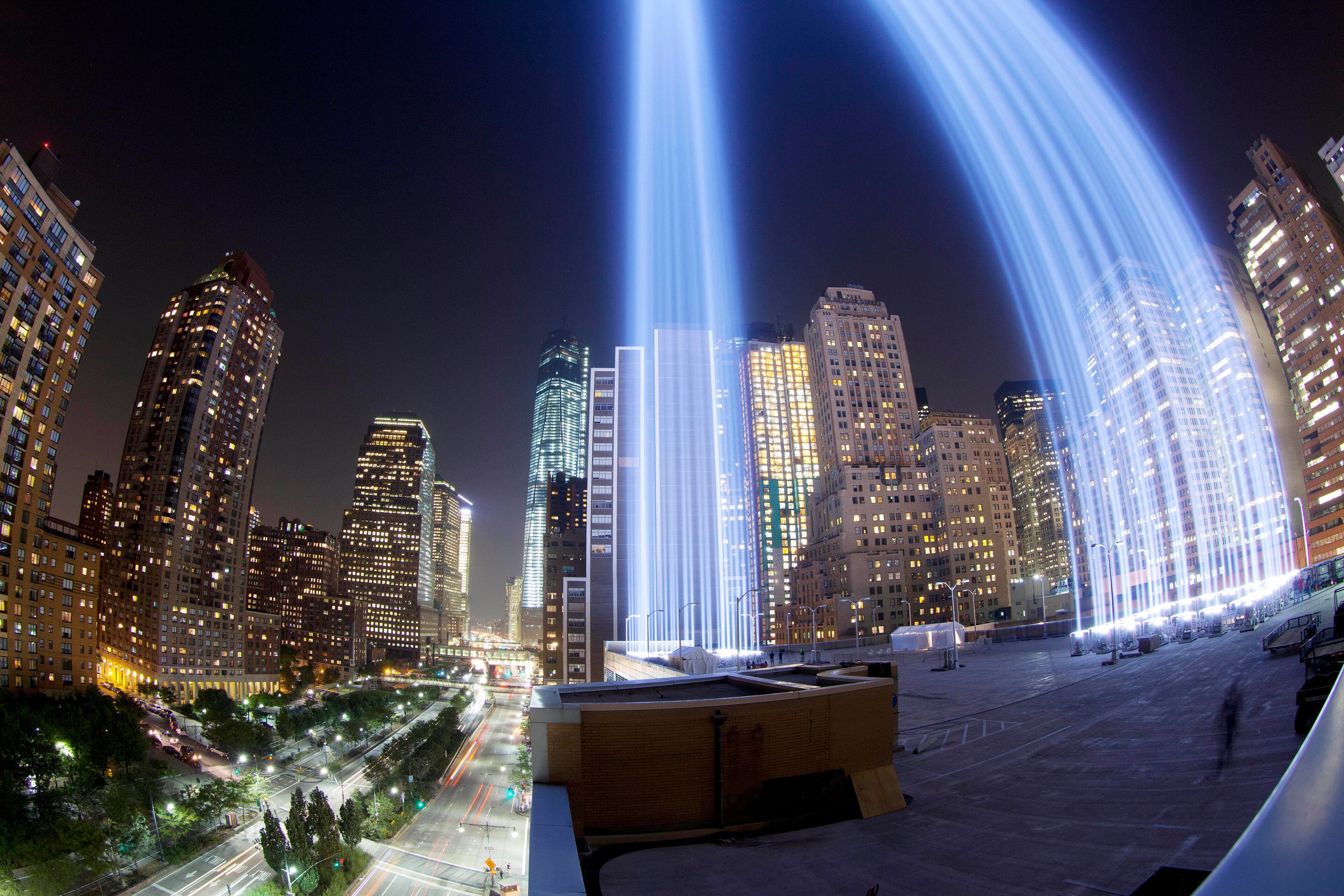 In a photo made with a fisheye lens, the Tribute in Light rises above buildings in lower Manhattan, during a test, Tuesday, Sept. 10, 2013 in New York. The light display commemorates the twin towers of the World Trade Center that were destroyed in terrorist attacks 12 years ago on Sept. 11, 2001. (AP Photo/Mark Lennihan)