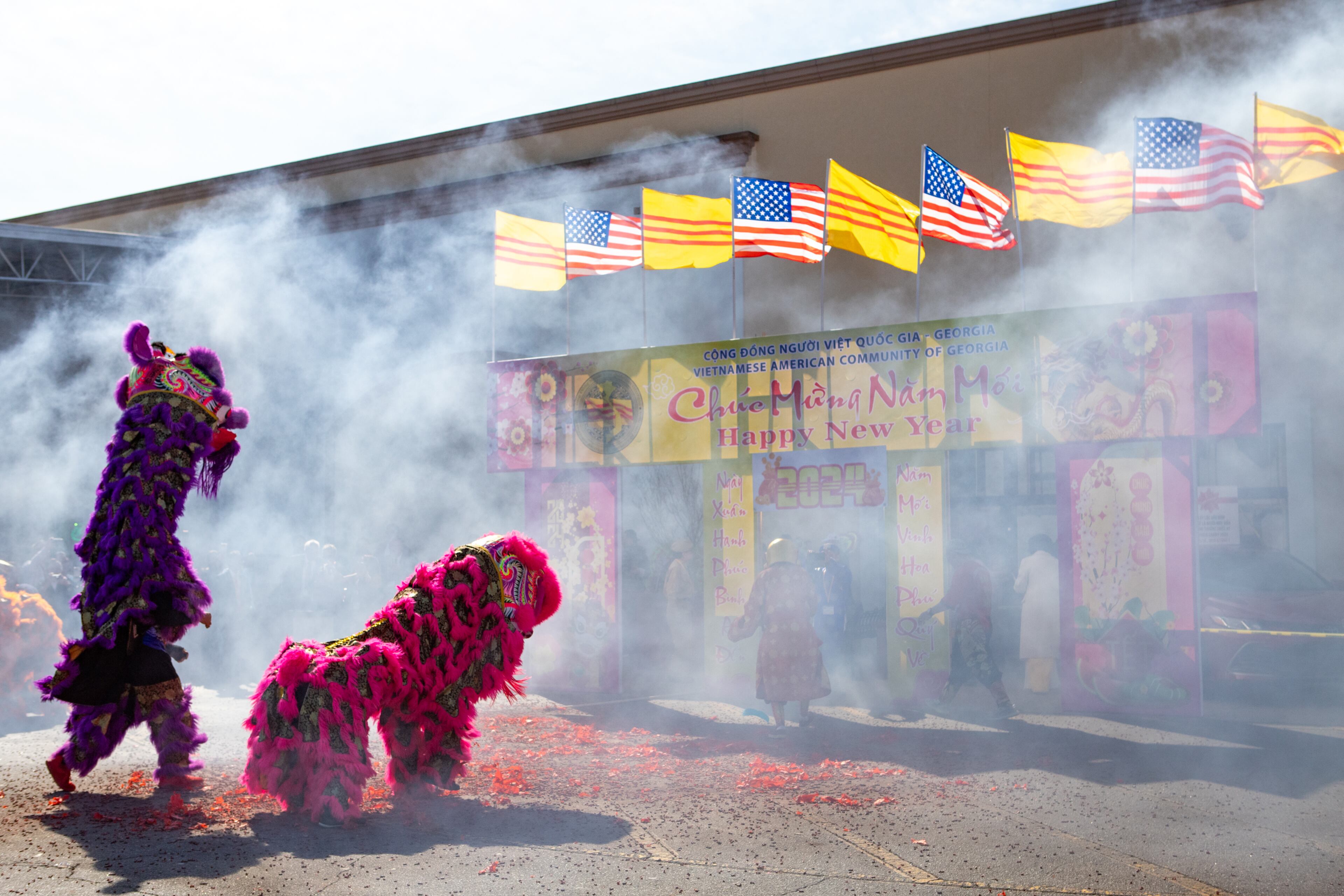 Lion dancers dance around firecrackers as festivities begin Saturday, Feb 3, 2024. The Vietnamese American Community of Georgia hosts a Lunar New Year celebration at Plaza Las Americas in Lilburn on where dragon and lion dancing begins the weekend. The celebration continues on Sunday and includes traditional food, music and cultural festivities. (Jenni Girtman for The Atlanta Journal-Constitution)
