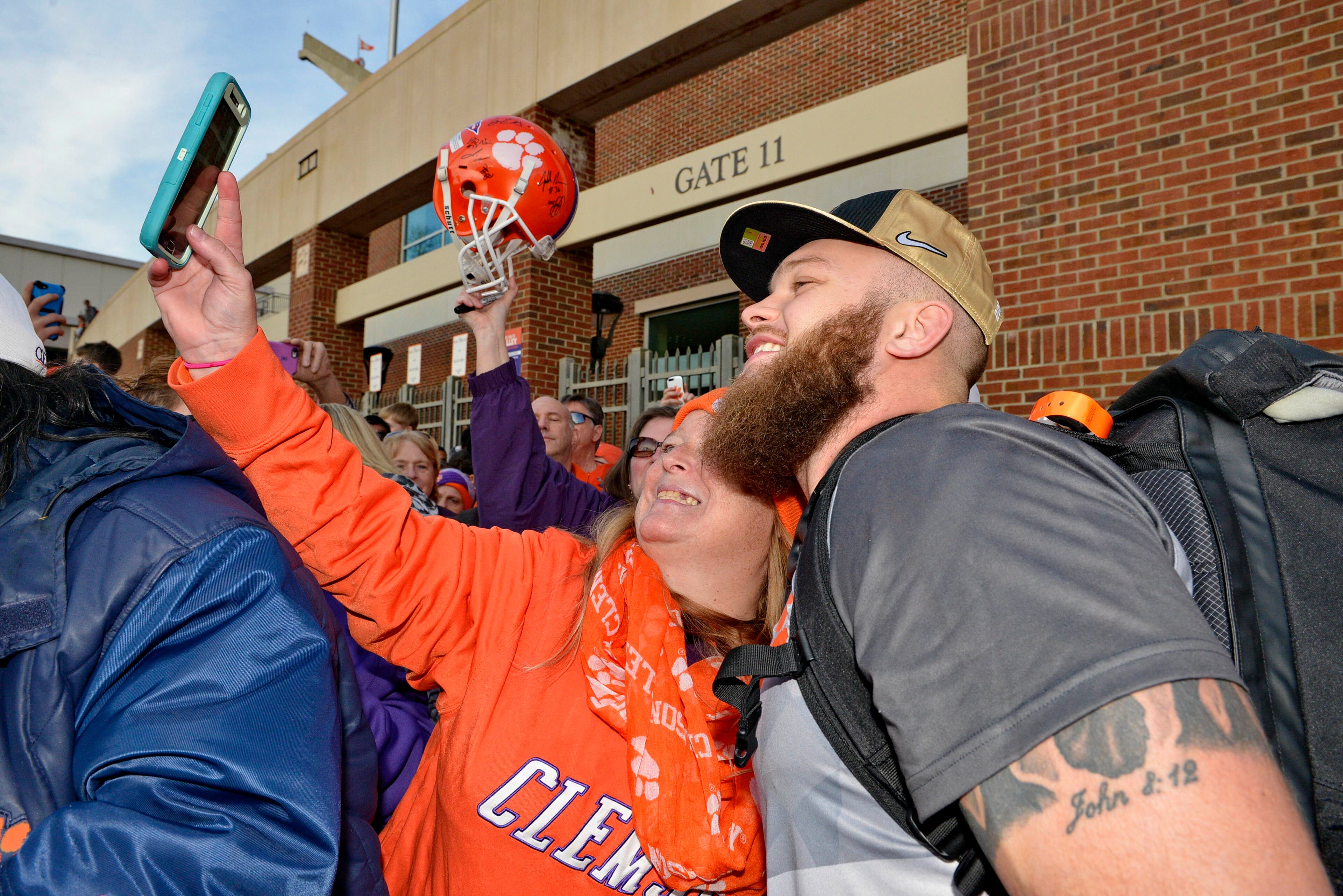 Clemson's Ben Boulware poses for photos with fans after returning Tuesday, Jan. 10, 2017, in Clemson, S.C., the day after the Tigers defeated Alabama 35-31 in the College Football Playoff championship NCAA college football game in Tampa. (AP Photo/Richard Shiro)