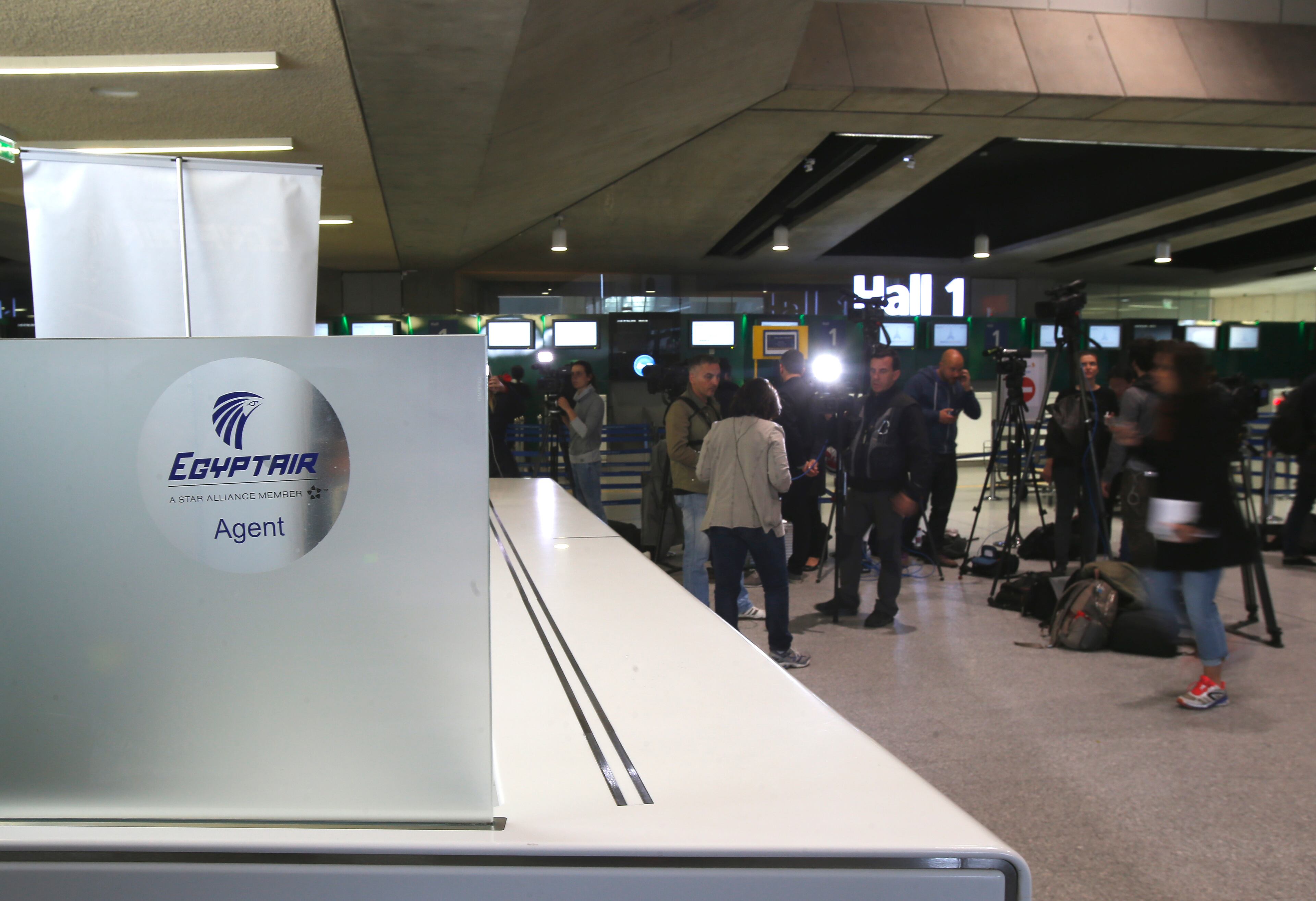 Reporters gather in front of the EgyptAir counter at Charles de Gaulle Airport outside of Paris, Thursday, May 19, 2016. An EgyptAir flight from Paris to Cairo carrying 66 people disappeared from radar early Thursday morning, the airline said. (AP Photo/Raphael Satter) (AP Photo/Michel Euler)