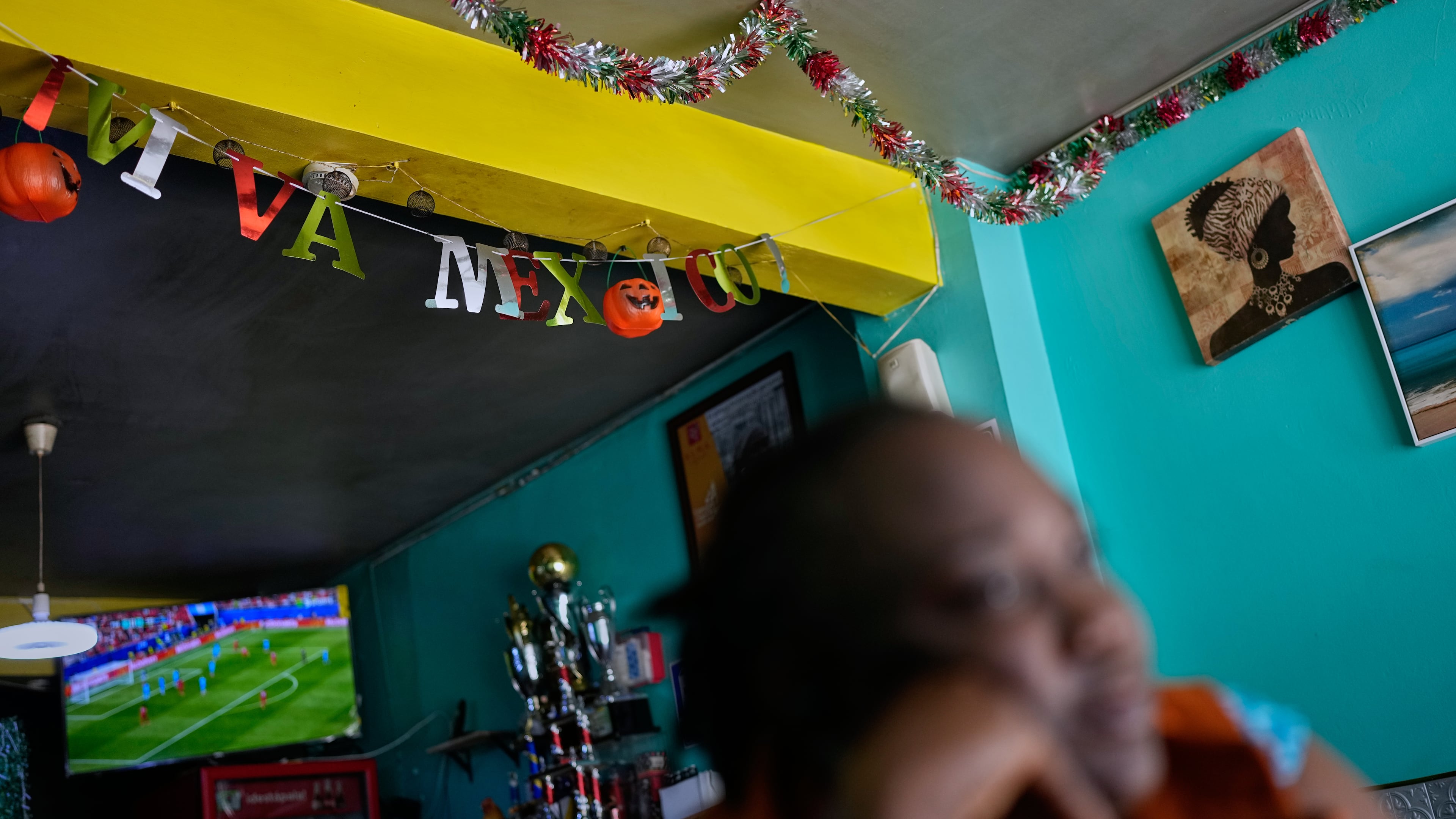 Vivianne Petit Frere looks on below a "viva Mexico" sign at her Haitian food restaurant, Lakou Lakay, June 17, 2026, in Tijuana, Mexico. (AP Photo/Gregory Bull)