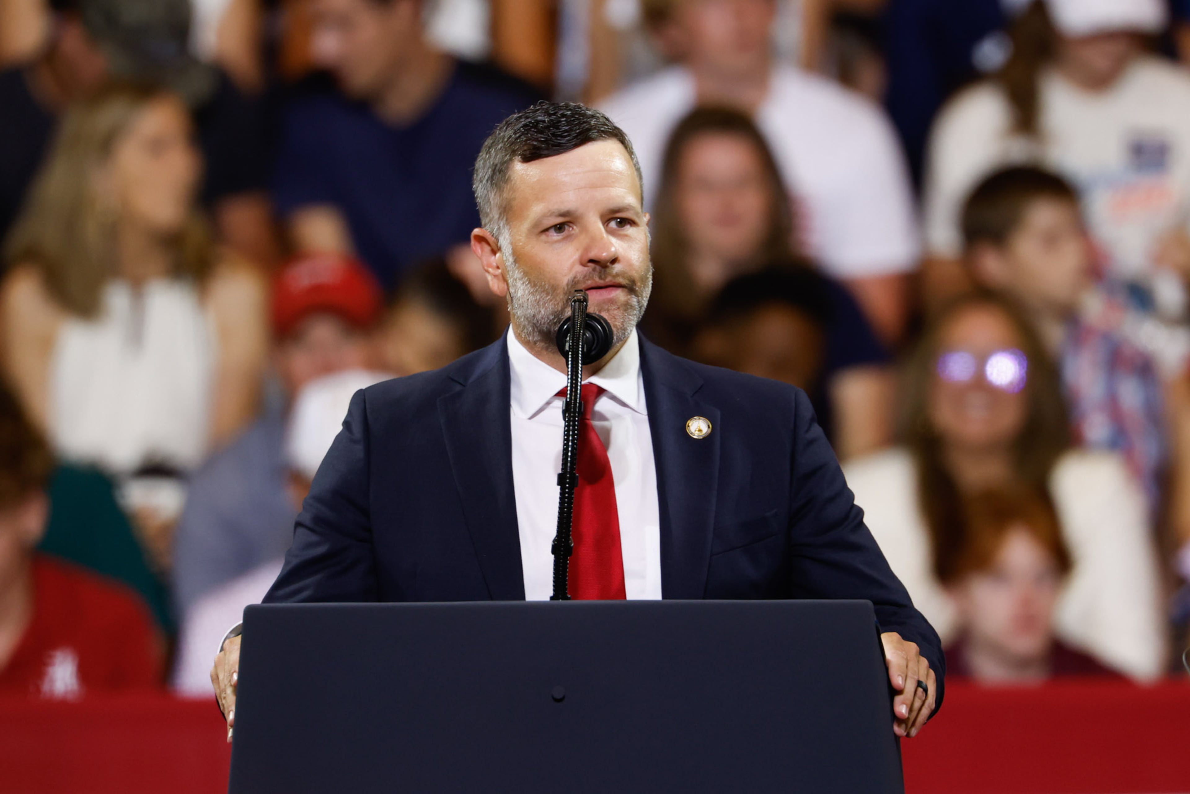 Republican State Rep. Tim Fleming speaks at President Donald Trump's rally at Wheeler High School in Marietta in July. (Arvin Temkar/AJC)