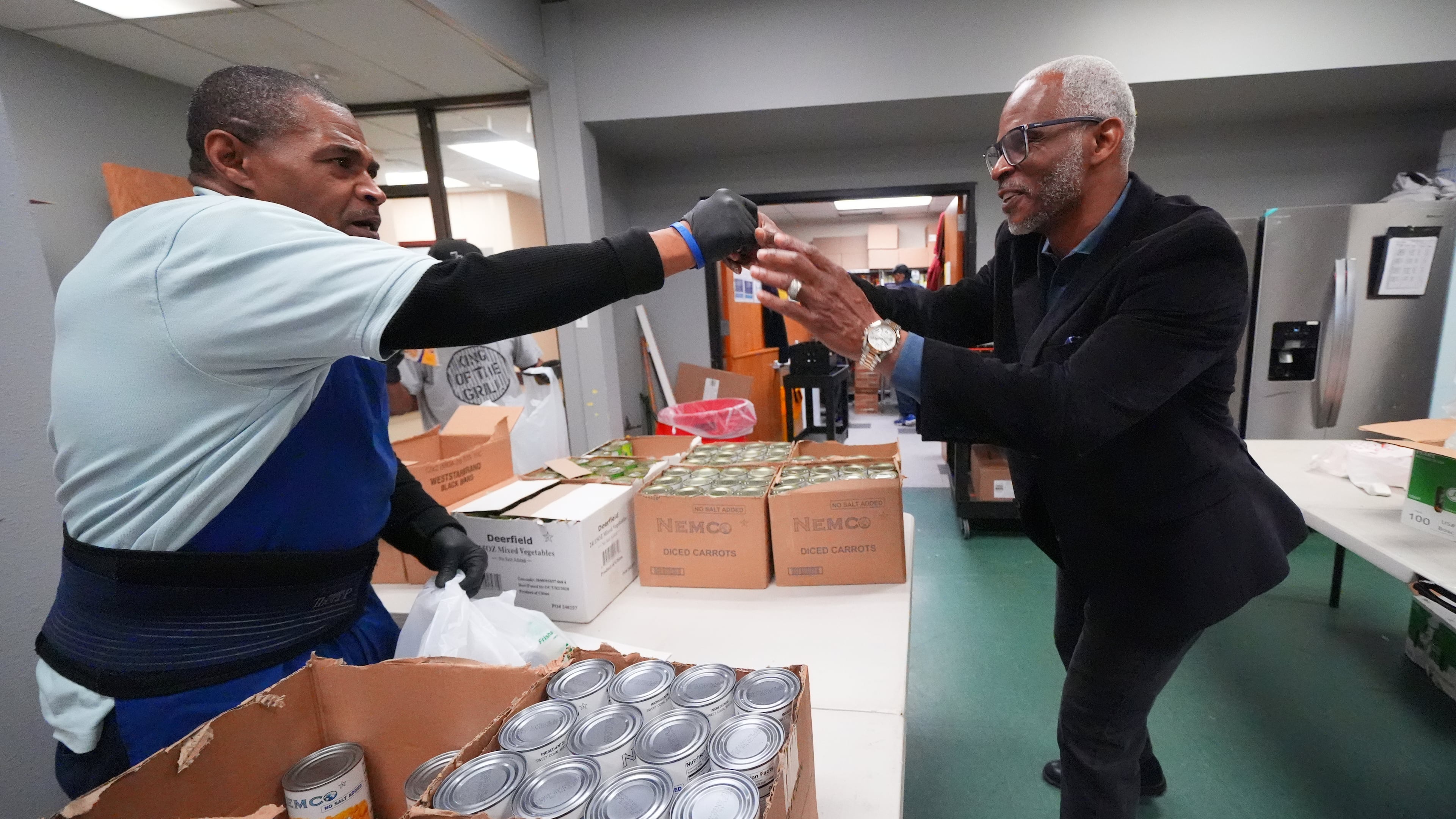 Richard Miles, right, founder and CEO of Miles of Freedom, a Dallas-based group that provides help for individuals after they have been released from prison, whether they are on parole or are exonerees, greets his organization's soup kitchen volunteer Frederick Briscoe on Tuesday, April 21, 2026 in Dallas. (AP Photo/Julio Cortez)