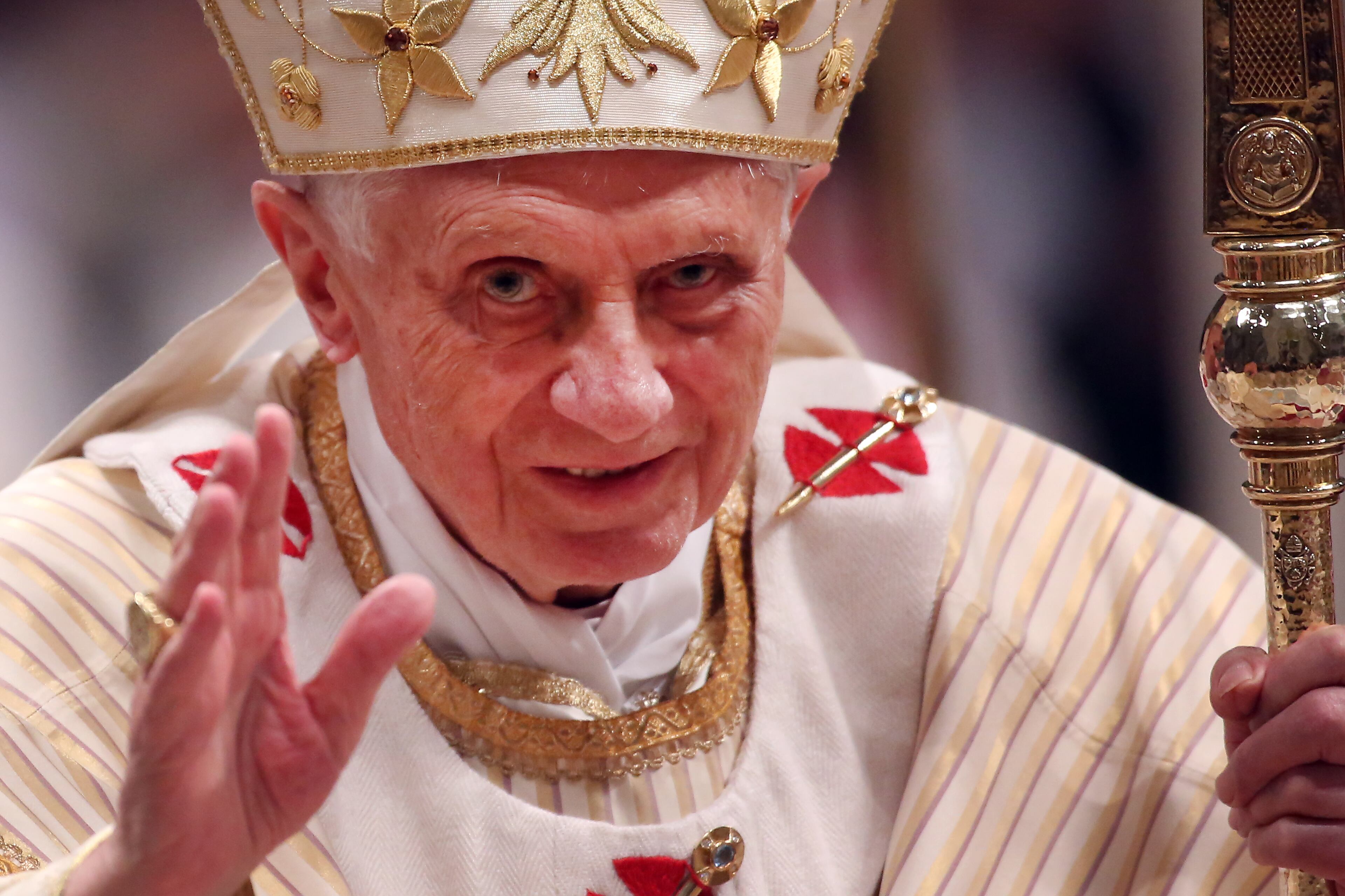 Pope Benedict XVI waves to the faithfuls as he leaves St. Peter's Basilica at the end of the Christmas night mass on December 24, 2012 in Vatican City, Vatican. (Photo by Franco Origlia/Getty Images)