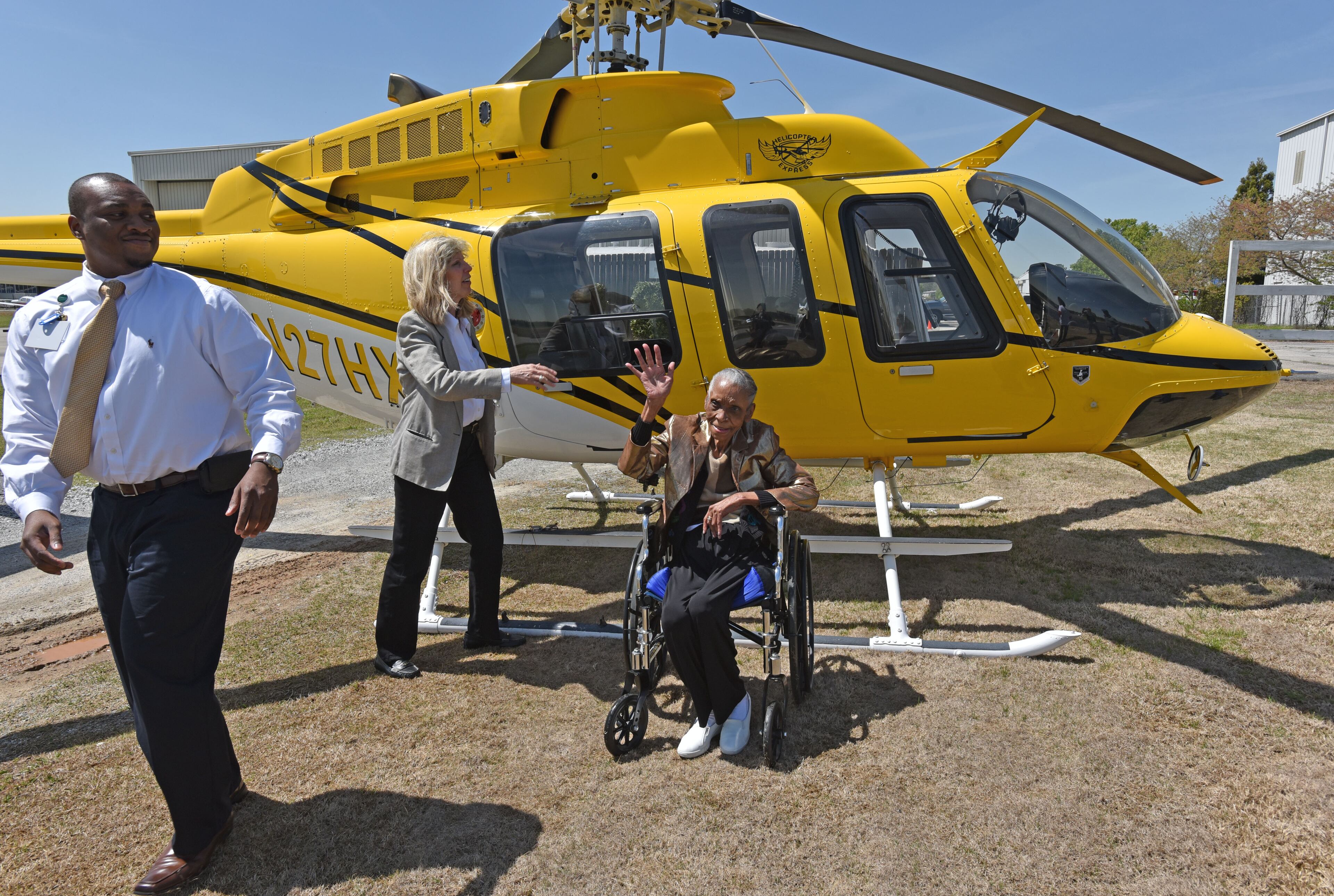 Thelma Knox waves after she completed her first flight. Knox, 84, has always dreamed of flying in a helicopter. After an introduction to the staff at Helicopter Express and safety prep, Knox, a resident of Pruitt Health Decatur, and her son, Lee Knox, boarded the helicopter and enjoyed a 30-minute tour over Atlanta, exploring Stone Mountain, downtown and Buckhead. HYOSUB SHIN / HSHIN@AJC.COM