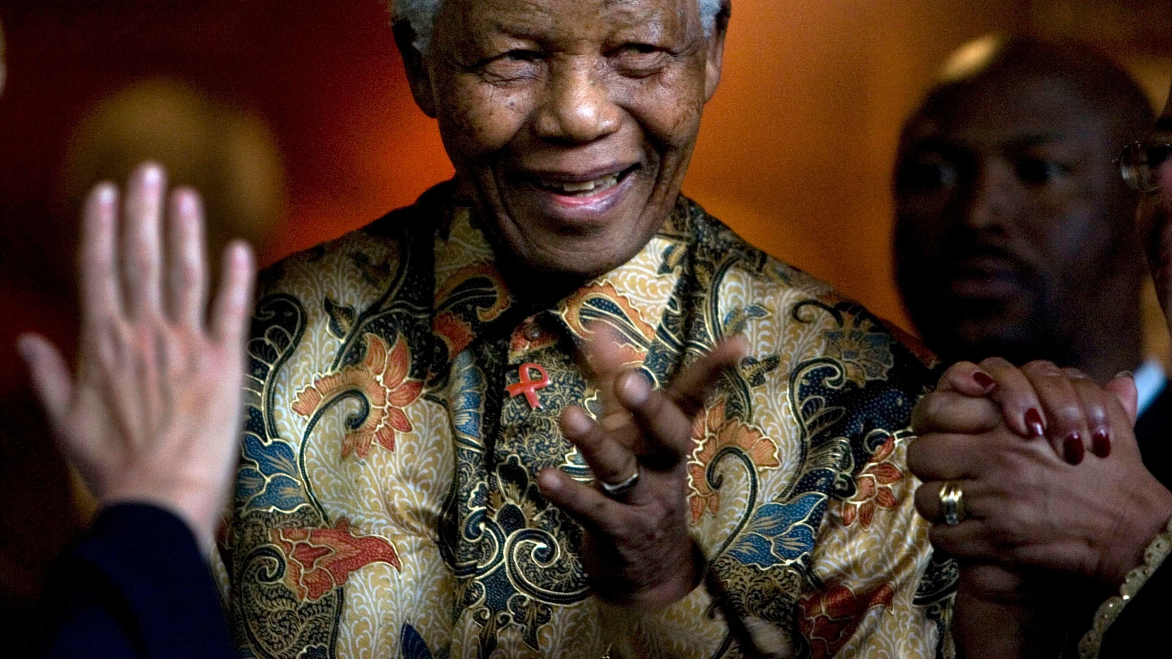 Former South African President Nelson Mandela reacts after a meeting at the Nelson Mandela Foundation building in Johannesburg, South Africa in 2007.