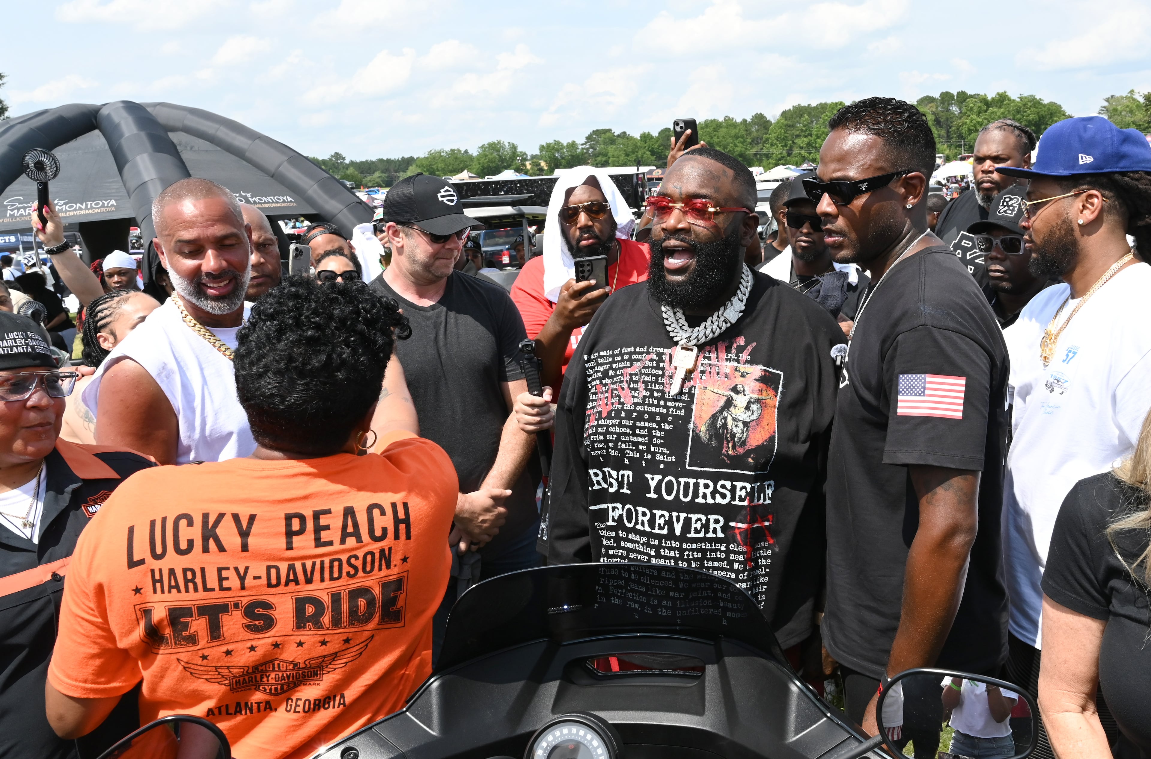 Rick Ross meets and greets attendees and vendors during the 4th Annual Rick Ross Car and Bike Show, Saturday, June 7, 2025, in Fayetteville. The 4th Annual Rick Ross Car and Bike Show will include a vendor market with more than 30 vendors, food trucks, fleets of classic/custom automobiles, luxury vehicles, boats, RVs and trailers on the front of the mansion. Stage performances include Plies, Ross' new signee Nino Breeze and Ross himself. (Hyosub Shin / AJC)