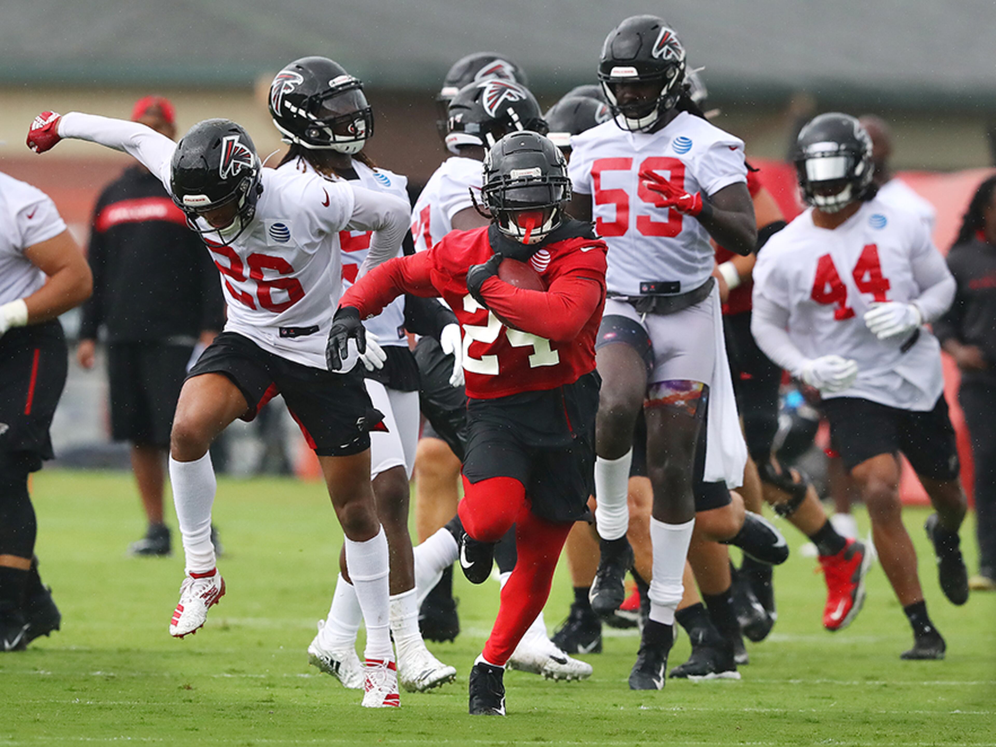 Falcons running back Devonta Freeman breaks away from the defense for yardage during the second practice of training camp Tuesday, July 23, 2019, in Flowery Branch.