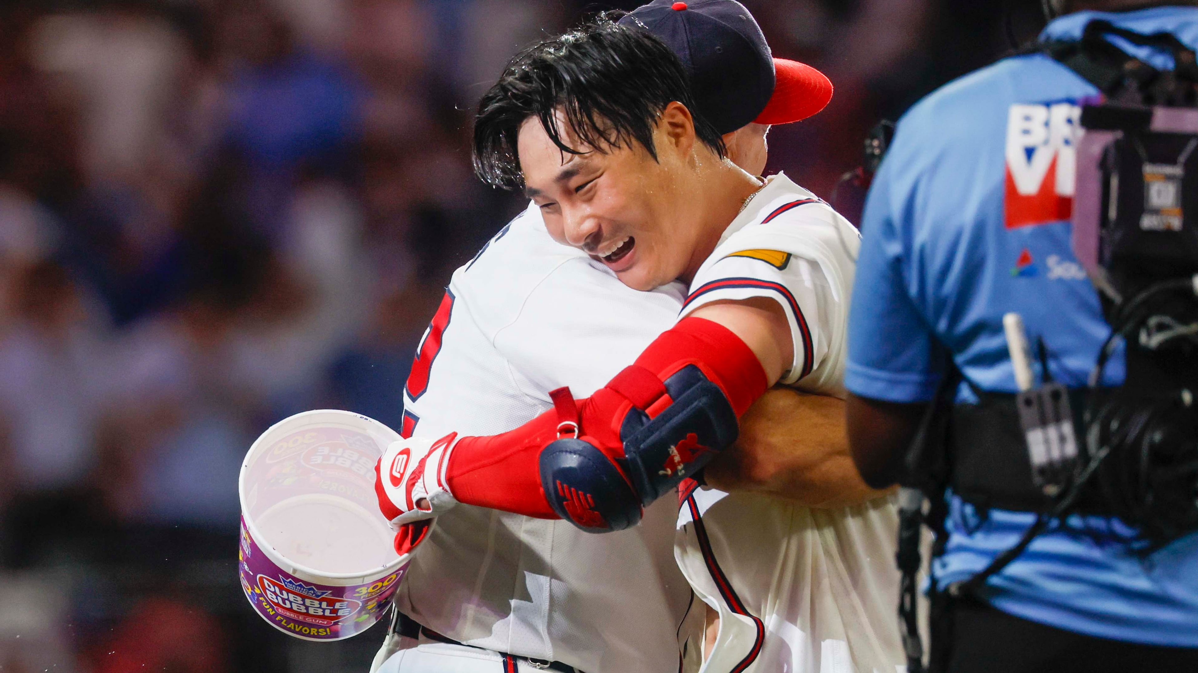 Atlanta Braves manager Walt Weiss (22) hugs Braves shortstop Ha-Seong Kim (7) after Kim’s walk-off single in the ninth inning against the Los Angeles Dodgers at Truist Park in Atlanta on Wednesday, August 26, 2026. The Braves defeated the Dodgers 6-5. (Miguel Martinez/ AJC)