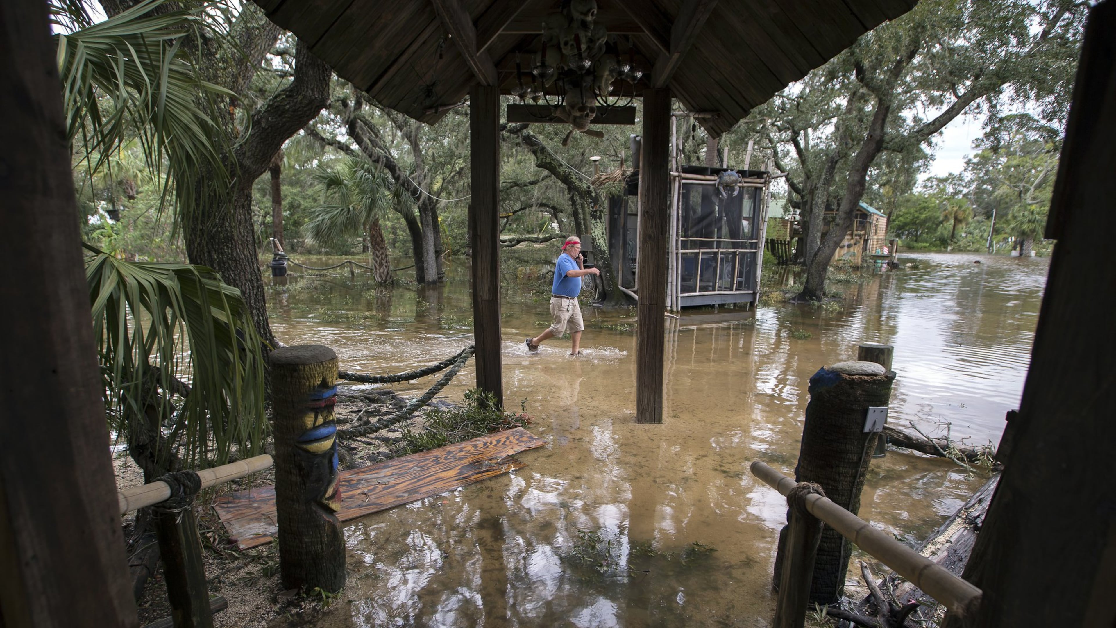 A Crab Shack restaurant employee walks through the business near Tybee Island, Ga., after winds and storm surge from Hurricane Matthew hit the small community along the east coast of Georgia, Saturday, Oct. 8, 2016. (AP Photo/Stephen B. Morton)