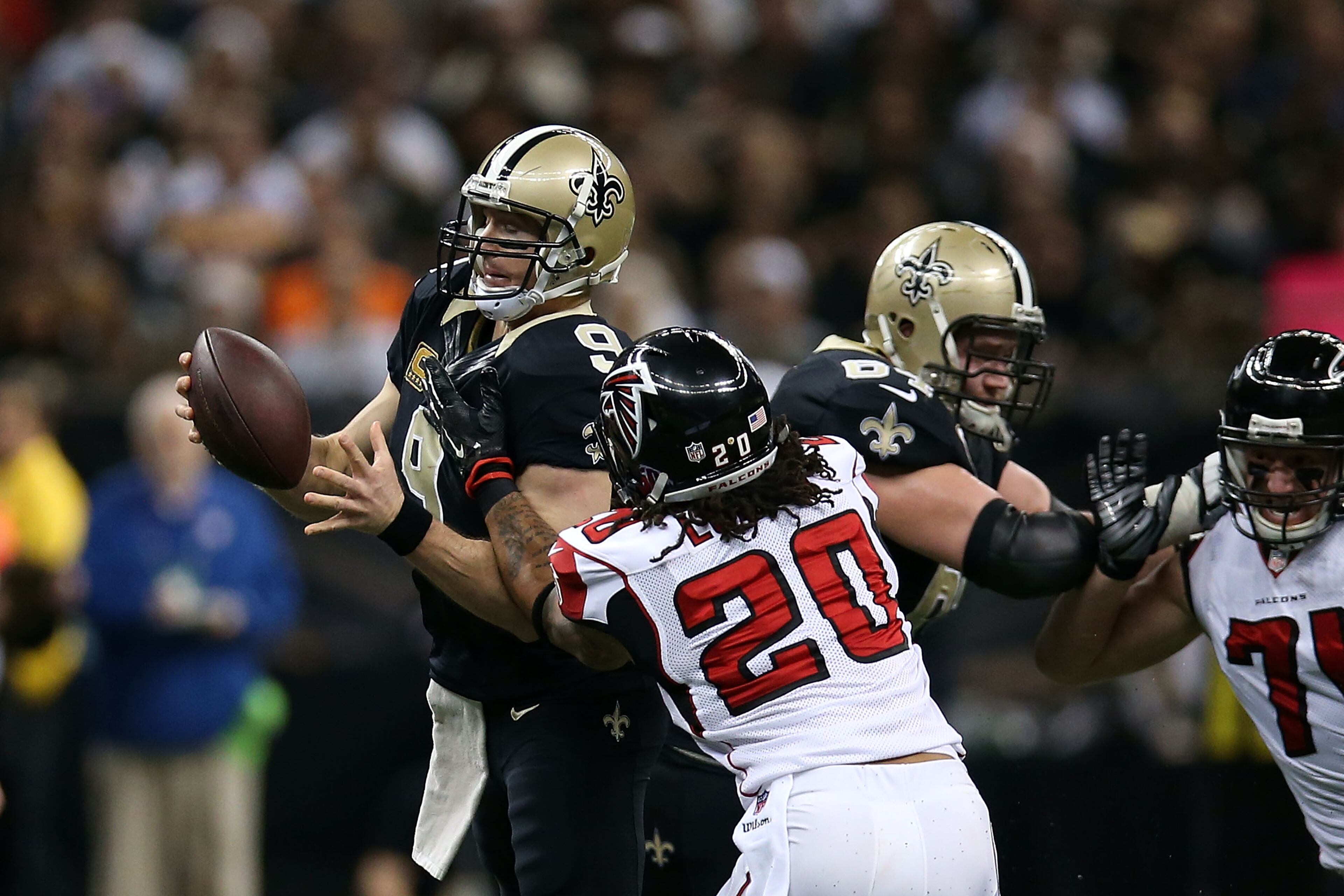 NEW ORLEANS, LA - DECEMBER 21: Drew Brees #9 of the New Orleans Saints is pressured by Dwight Lowery #20 of the Atlanta Falcons during the second quarter of a game at the Mercedes-Benz Superdome on December 21, 2014 in New Orleans, Louisiana. (Photo by Chris Graythen/Getty Images)