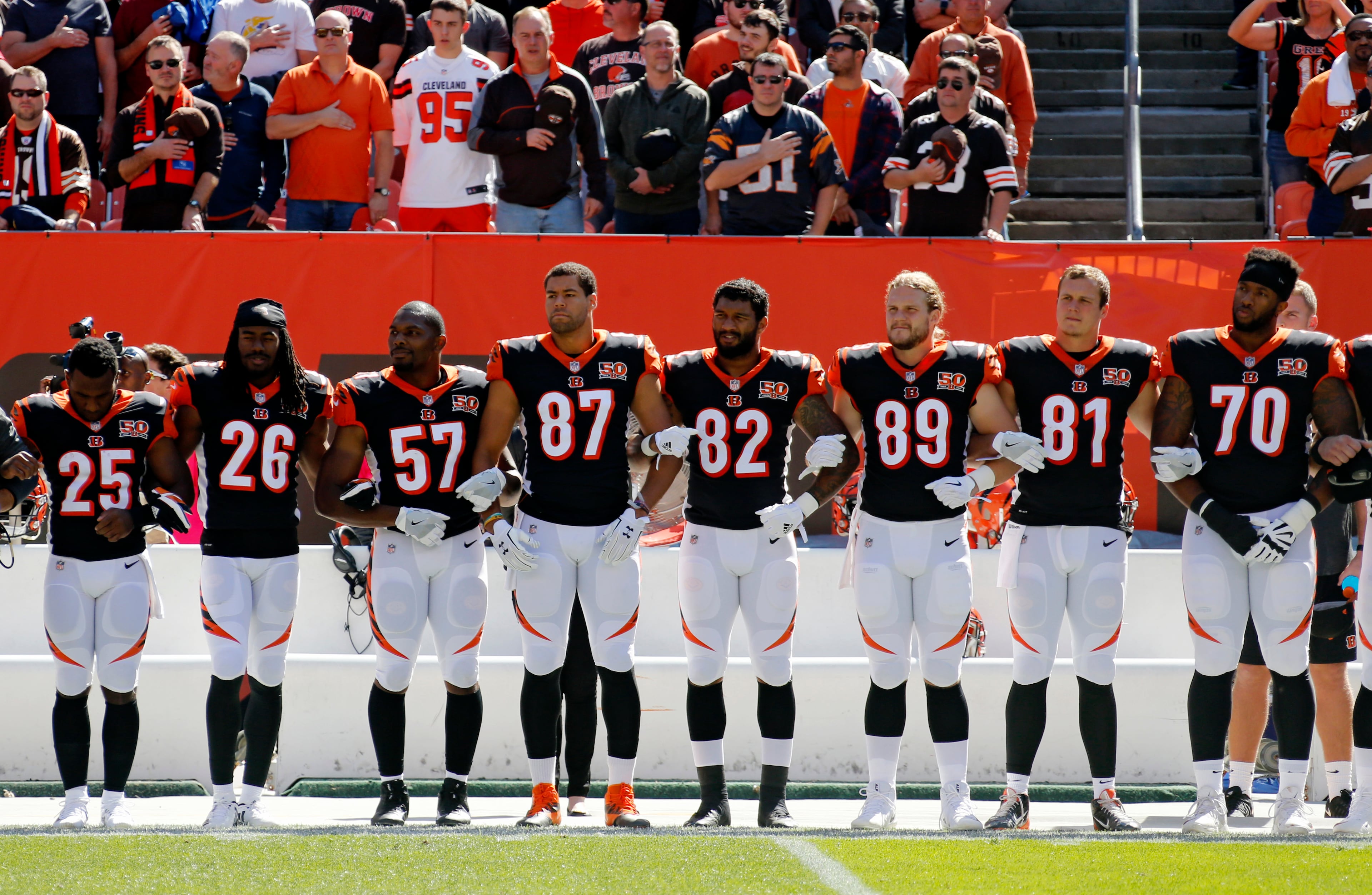 Cincinnati Bengals players lock arms during the national anthem before an NFL football game against the Cleveland Browns, Sunday, Oct. 1, 2017, in Cleveland. (AP Photo/Ron Schwane)