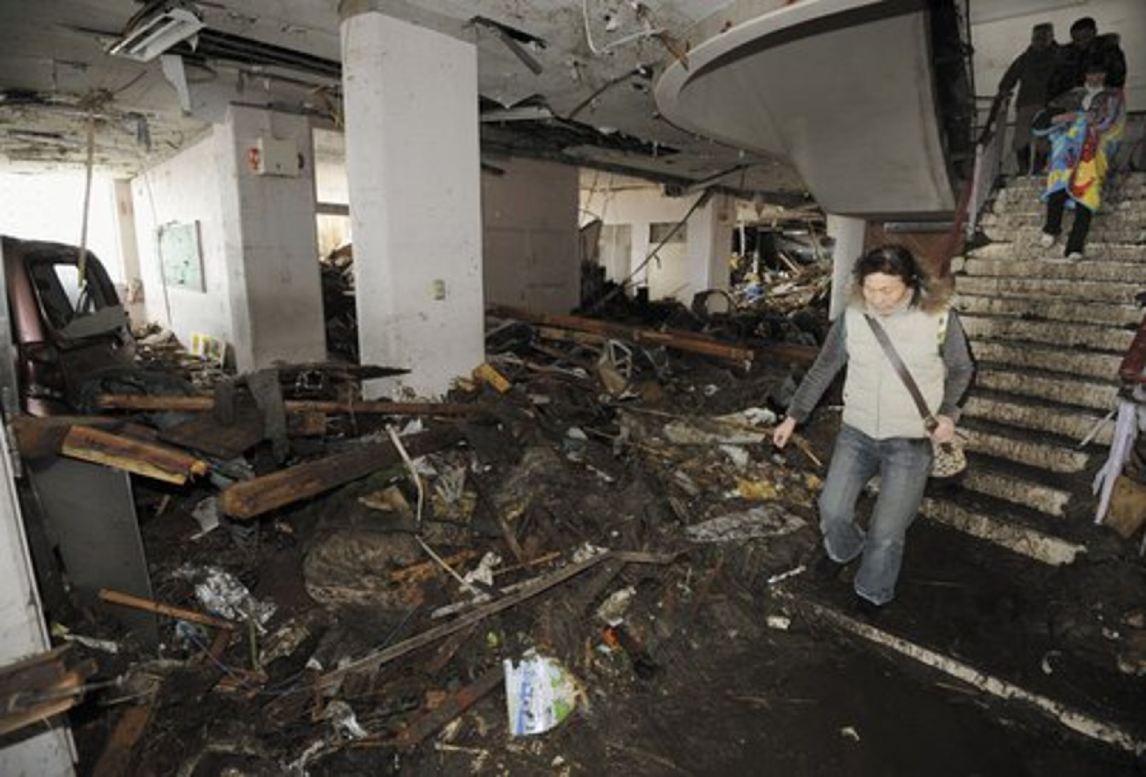 People walk past the first floor of an elementary school devastated by the tsunami in Sendai, northern Japan.