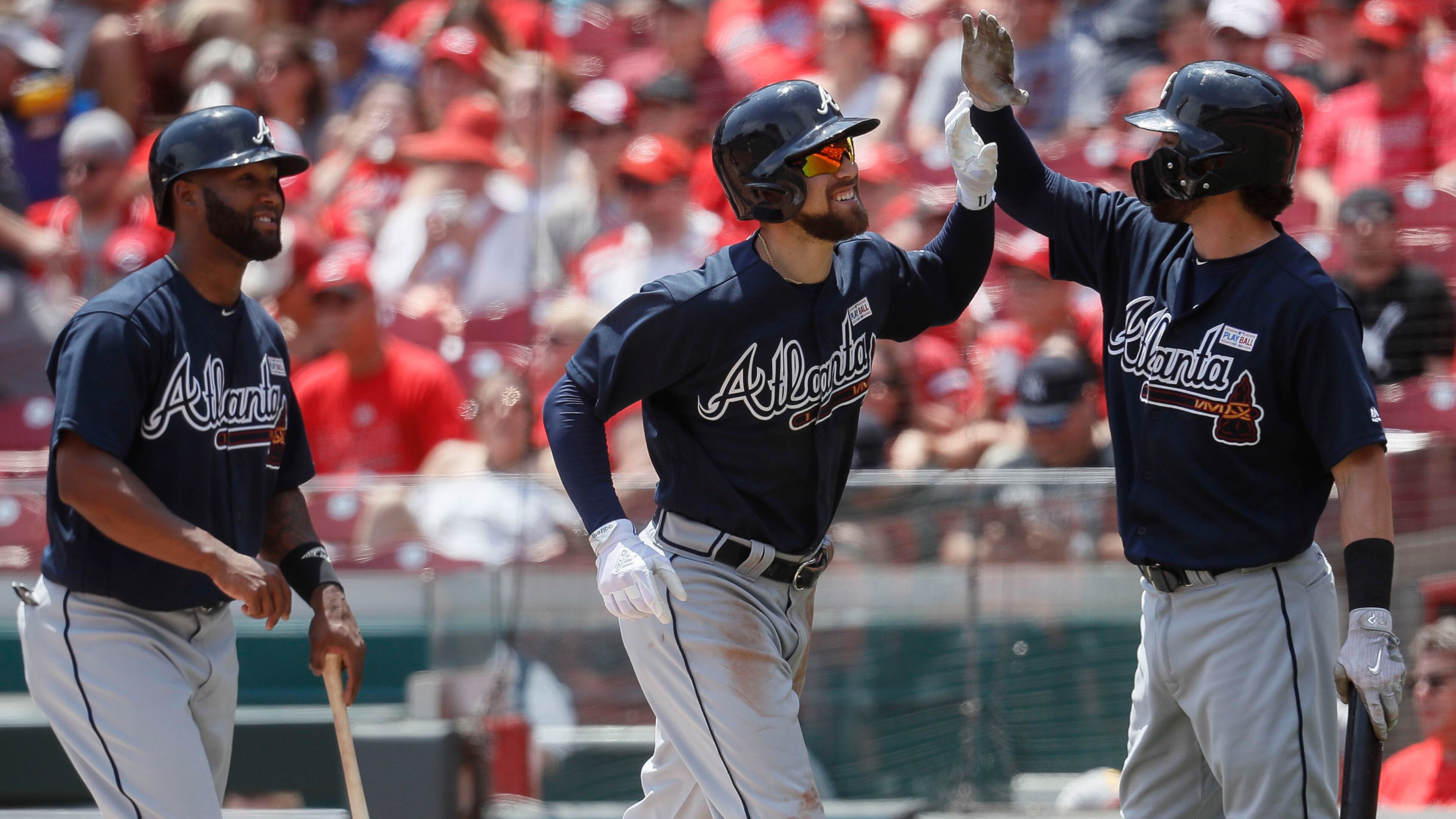 Atlanta Braves' Ender Inciarte (center) celebrates with Dansby Swanson (right) after hitting a three-run home run off Cincinnati Reds starting pitcher Amir Garrett in the third inning Sunday, June 4, 2017, in Cincinnati.