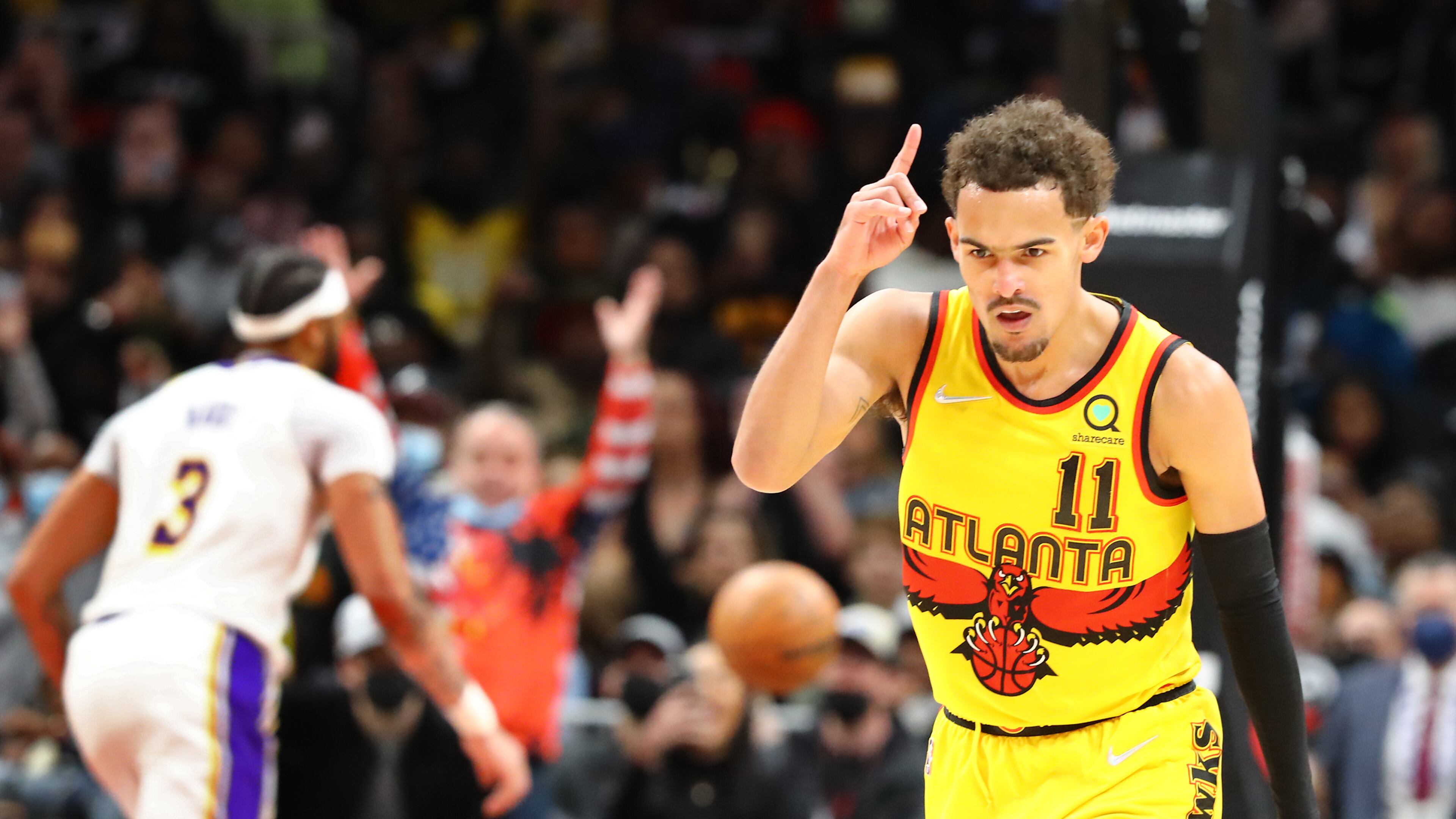 013022 Atlanta: Atlanta Hawks guard Trae Young reacts to hitting a three pointer against the Los Angeles Lakers to take a 121-116 lead during the 4th period of an NBA basketball game on Sunday, Jan. 30, 2022, in Atlanta. The Hawks came from behind in the 4th period to beat the Lakers 129-121. “Curtis Compton / Curtis.Compton@ajc.com”`