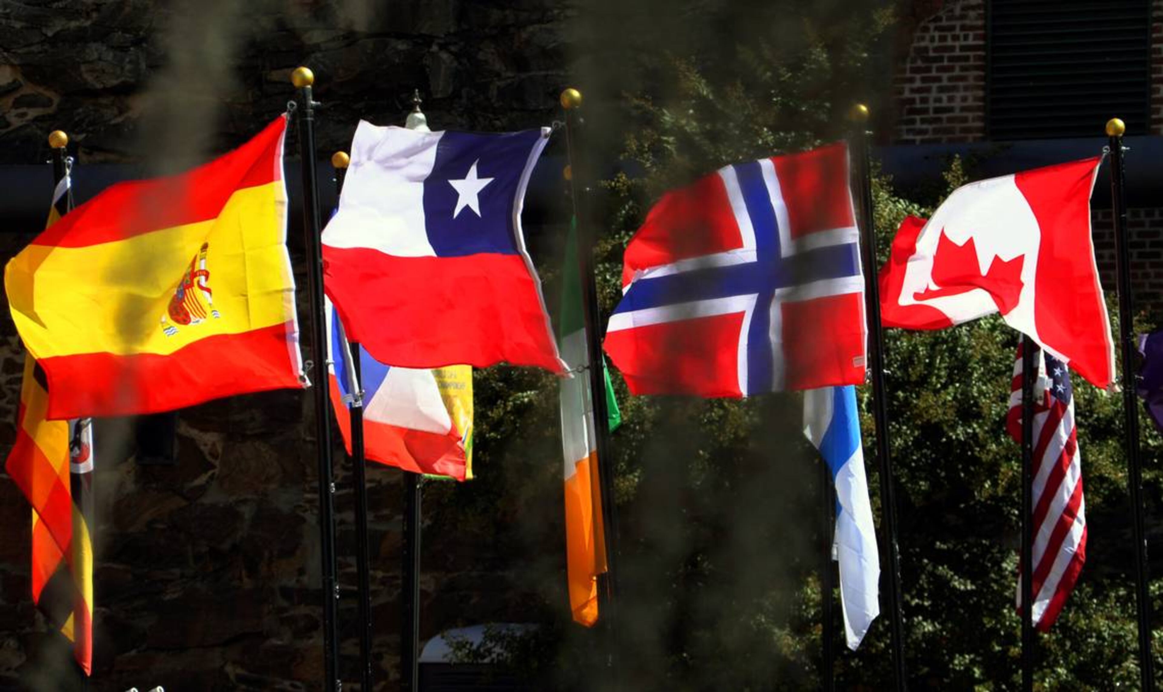 Flags representing the competitors in the 2023 ICF Canoe Freestyle World Championships line the bridge to Waveshaper Island. (Photo Courtesy of Mike Haskey)