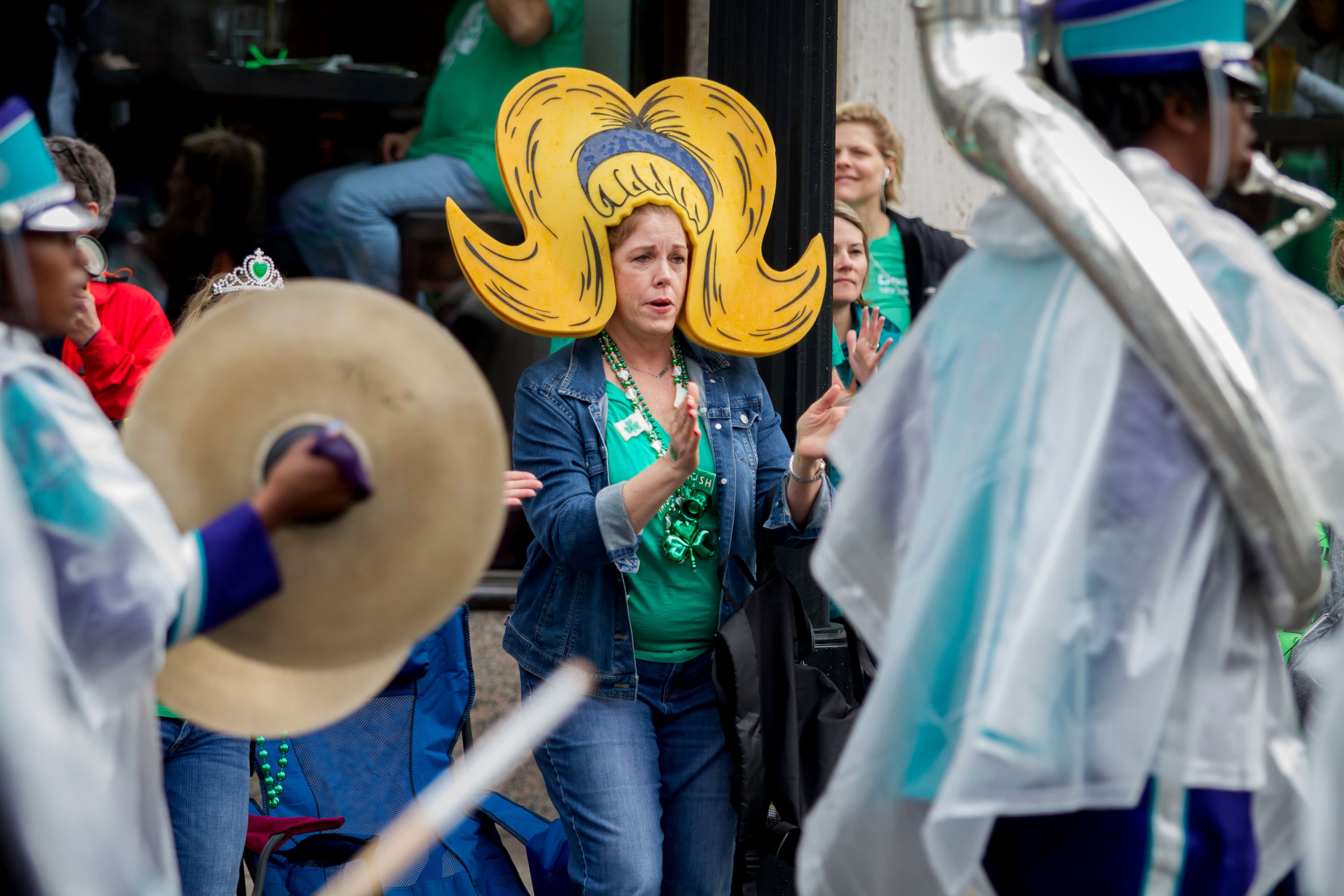 Carol White watches the parade in Midtown on Saturday, March 17, 2018. STEVE SCHAEFER / SPECIAL TO THE AJC