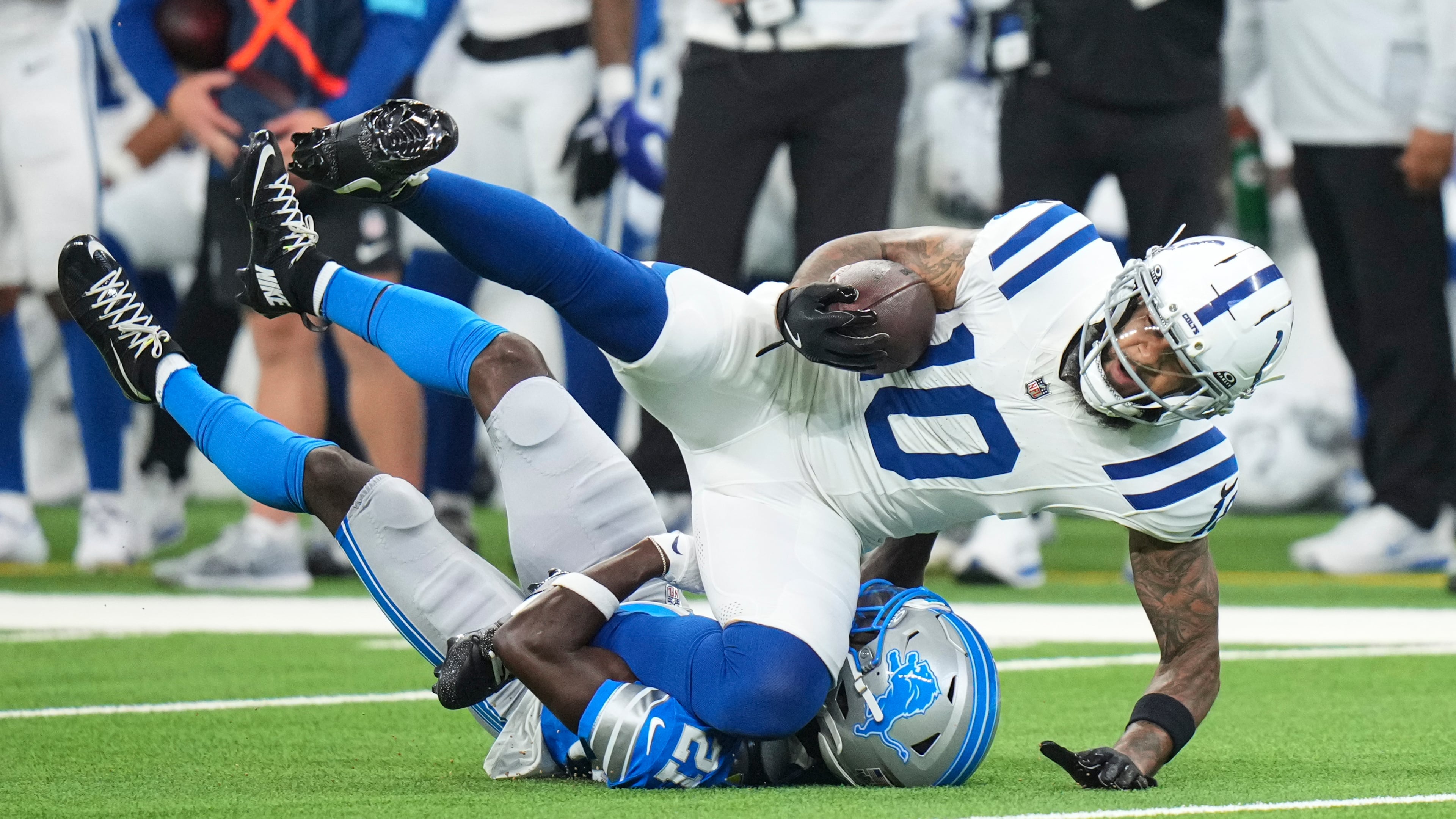 Indianapolis Colts wide receiver Keenan Allen (10) is tackled by Detroit Lions cornerback Roger McCreary (21) during the first half of a preseason NFL football game in Indianapolis, Saturday, Aug. 29, 2026. (AP Photo/AJ Mast)