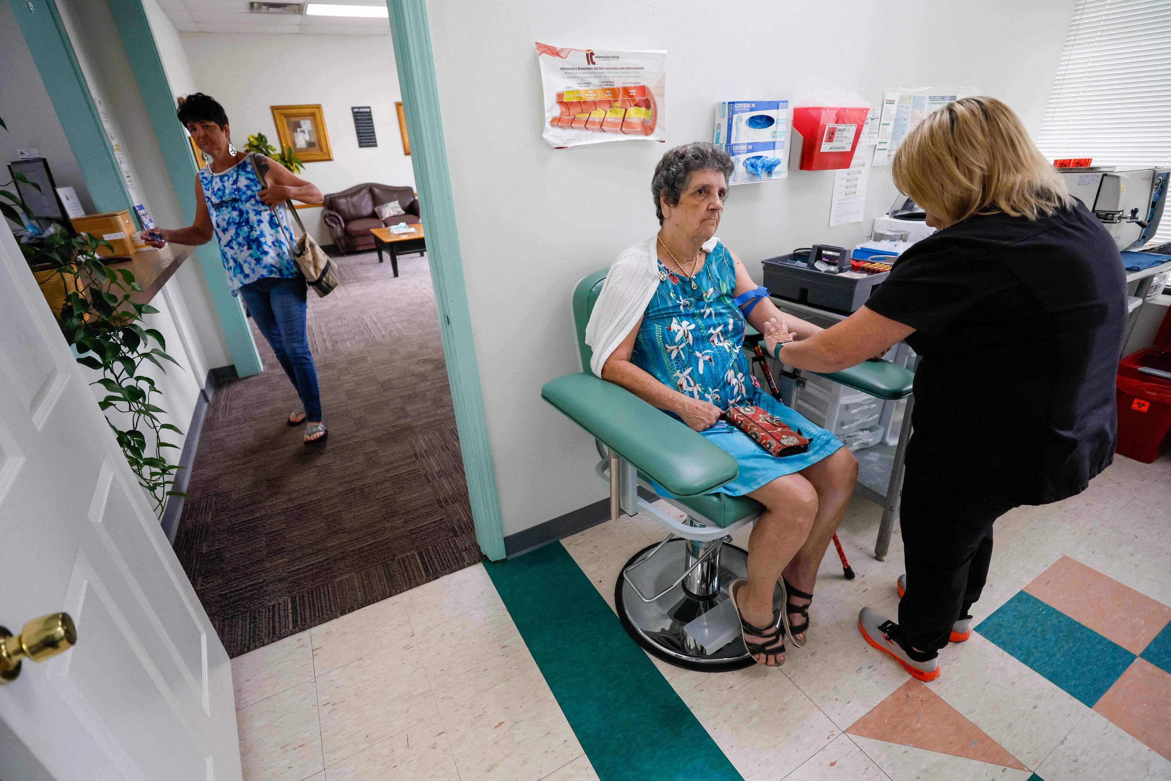 Faye Jackson gets her blood tested at a medical clinic in Calhoun, Ga., on Tuesday, Sept. 30, 2025, as her daughter Marie waits outside for her turn. (Miguel Martinez/Atlanta Journal-Constitution via AP)