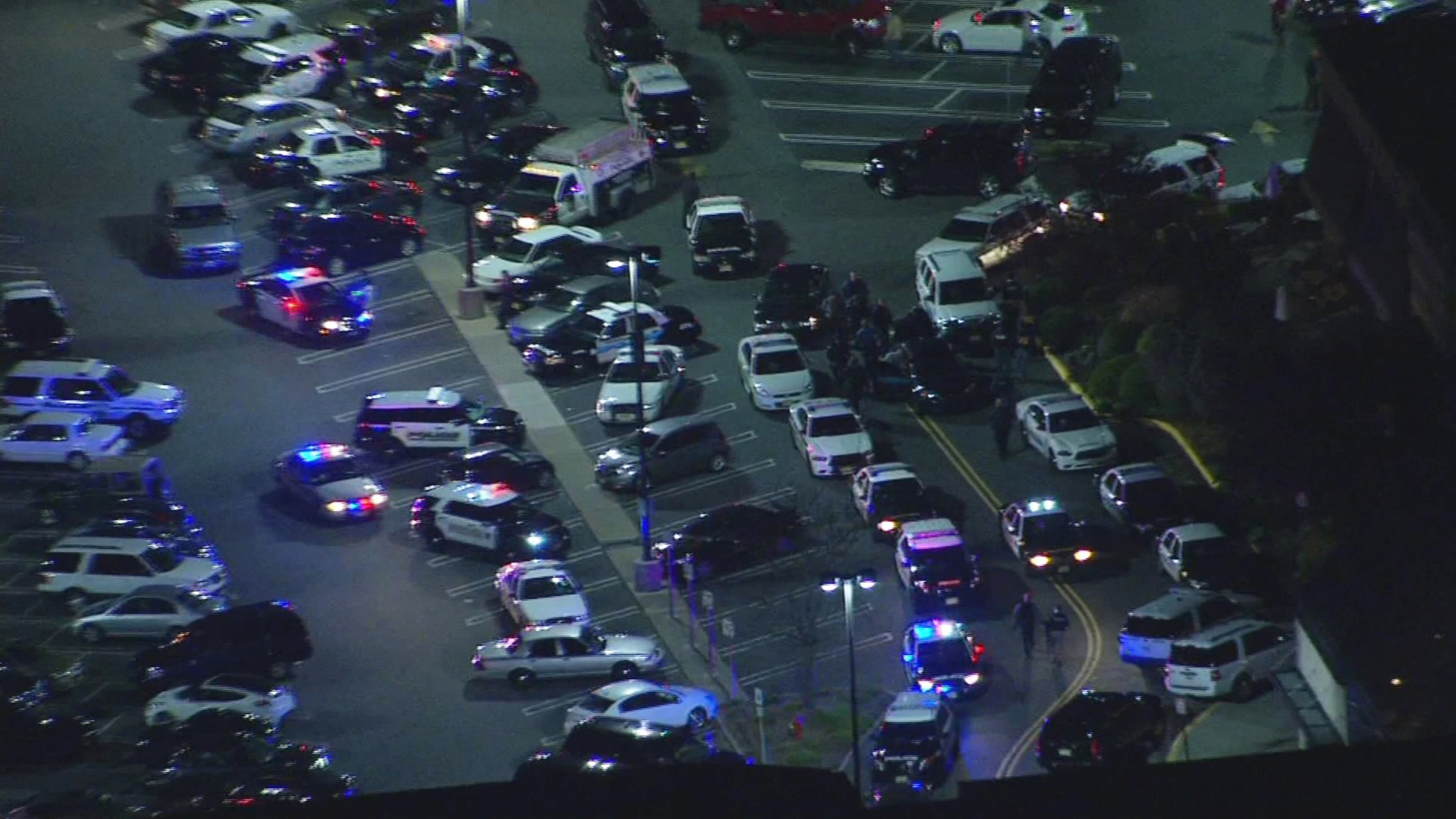 In this image provided by News 12 New Jersey, authorities converge on Garden State Plaza Mall, late Monday, Nov. 4, 2013, in Paramus, N.J., after there were reports of multiple shots being fired inside the mall. (AP Photo/News 12 New Jersey)