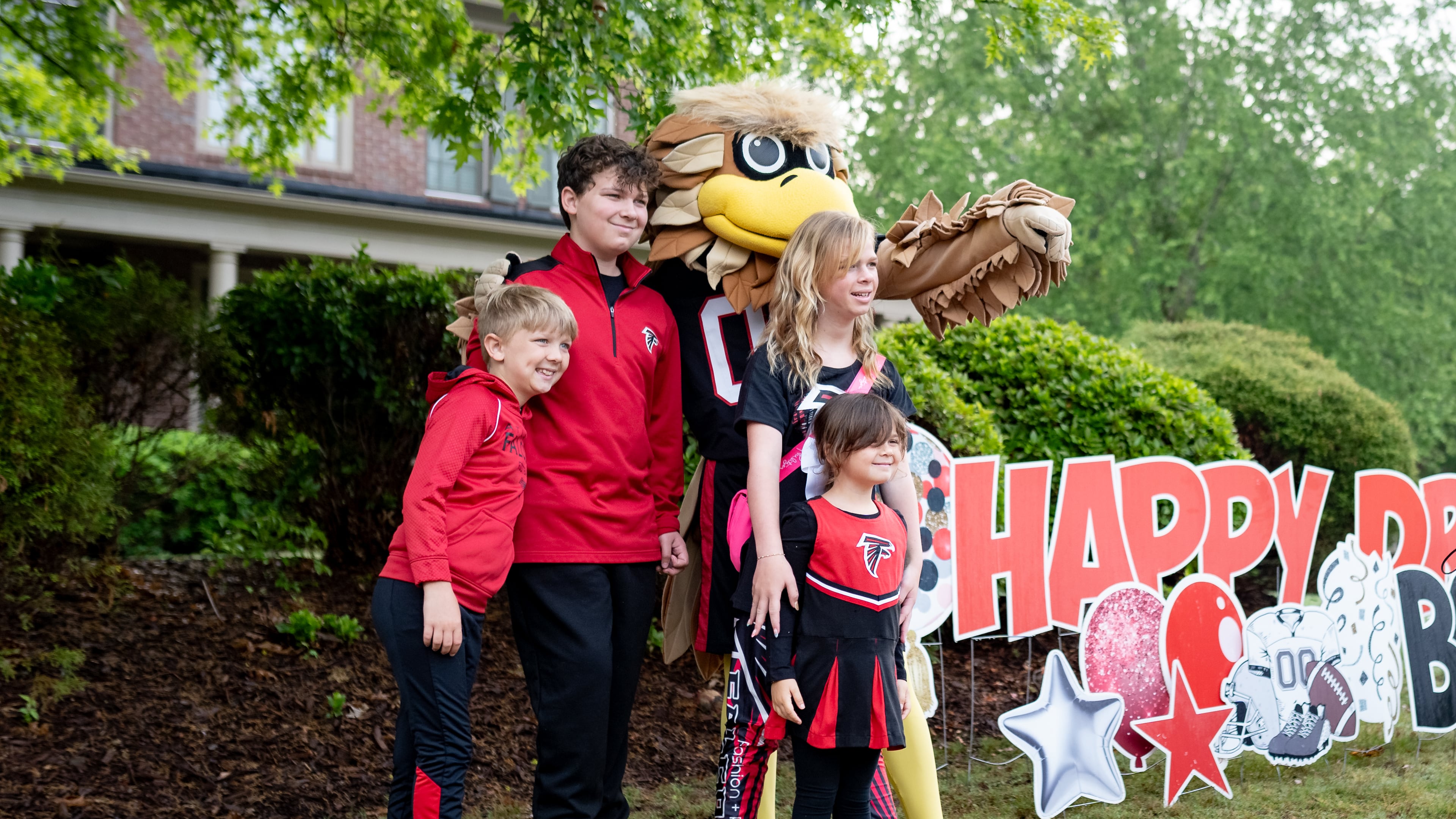 Bowen Harbuck, 13, poses with his siblings and Freddie Falcon outside his home in Peachtree City. (Ben Hendren for The Atlanta Journal-Constitution)