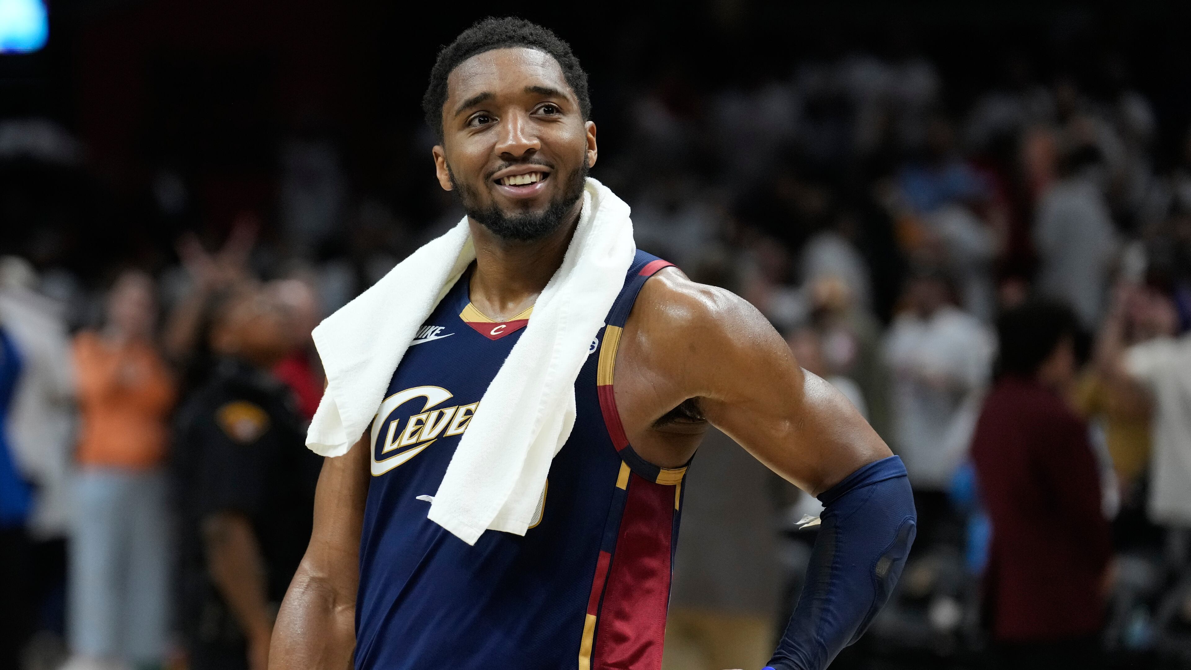 Cleveland Cavaliers guard Donovan Mitchell (45) smiles as fans cheer while he is interviewed after the Cavaliers defeated the Detroit Pistons in Game 3 of a second-round NBA playoffs basketball series Saturday, May 9, 2026 in Cleveland. (AP Photo/Sue Ogrocki)