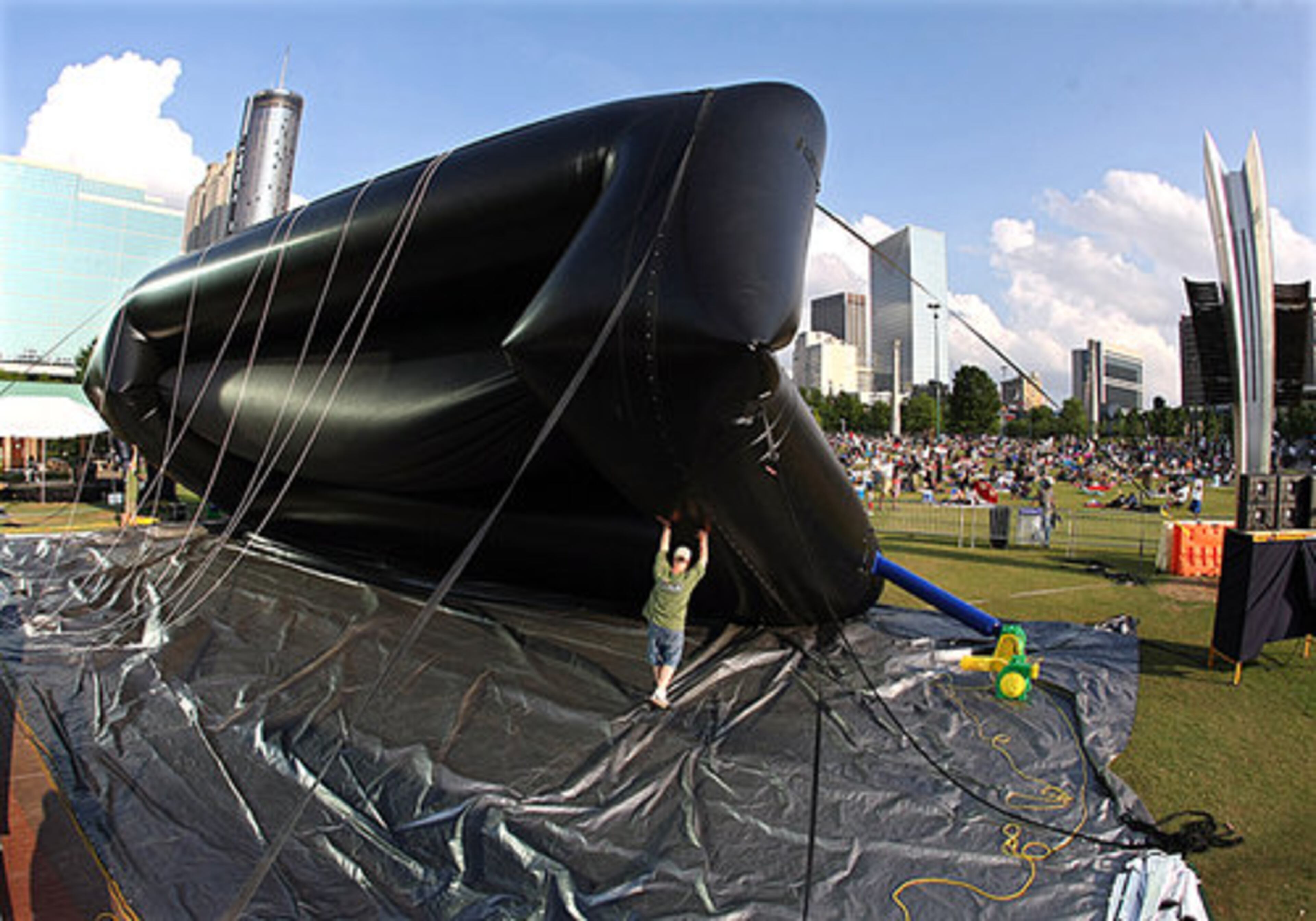 The crowd begins to gather on the grass as Paul Murray, owner of Southern Outdoor Cinema, and his crew raise the inflatable screen.