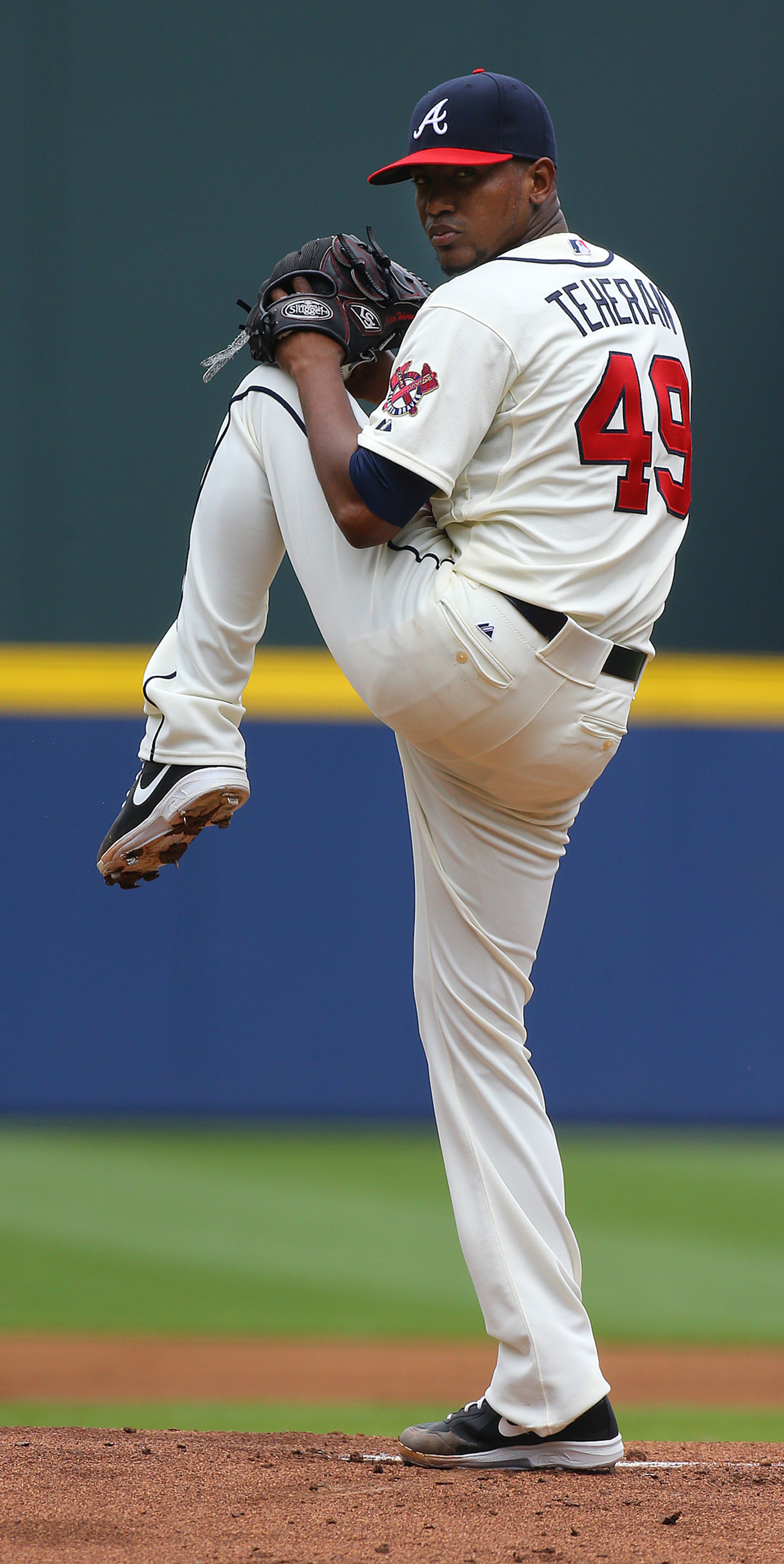 Julio Teheran, making his sixth start of the season and the 40th start of his career, delivers a pitch against the Reds during the first inning of a MLB baseball game on Sunday, April 27, 2014, in Atlanta. CURTIS COMPTON / CCOMPTON@AJC.COM