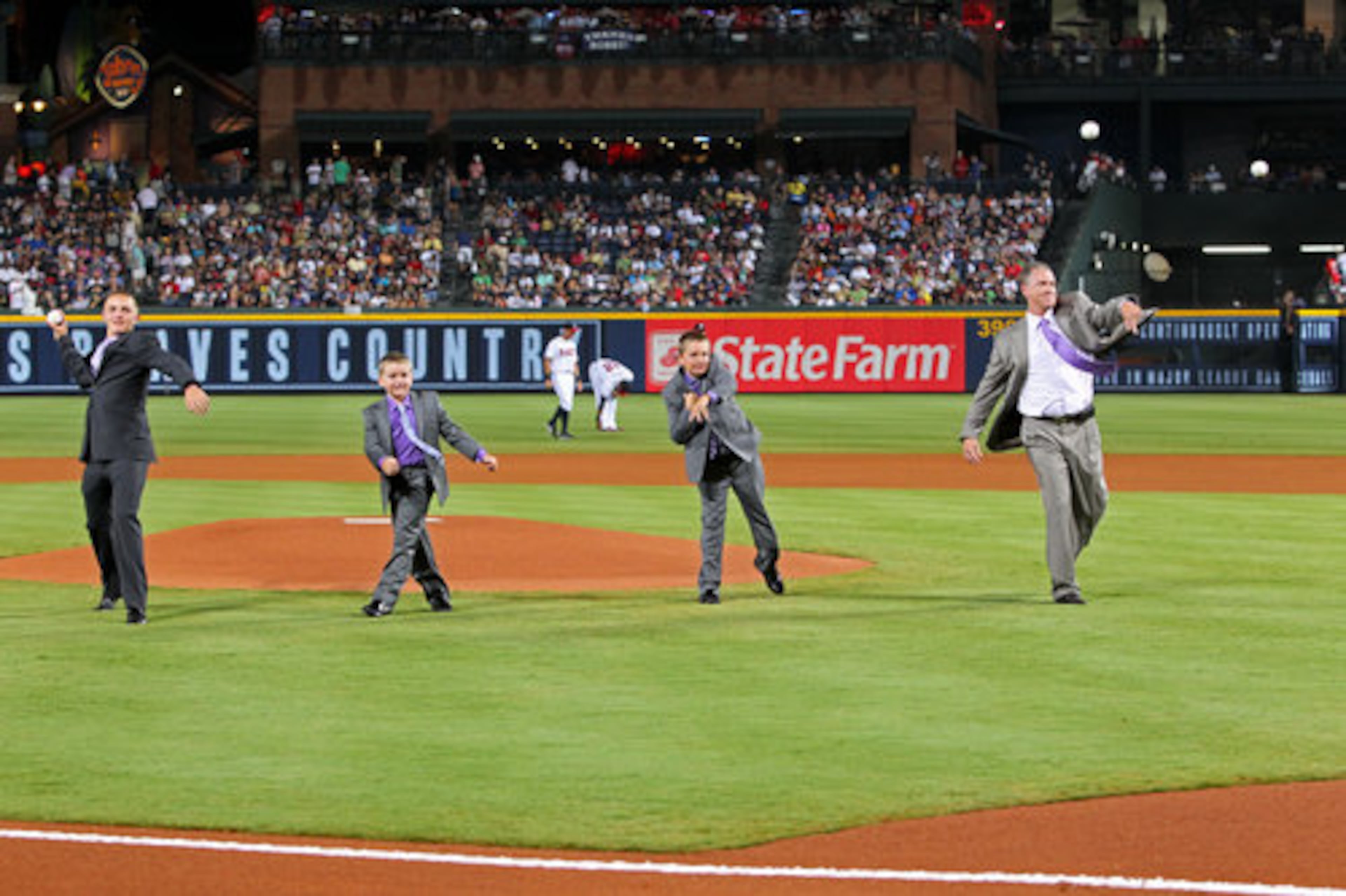Tom Glavine and his sons, from left, Jonathan, Mason, and Peyton, throw out the ceremonial first pitch following his uniform number retirement in a pre-game ceremony at Turner Field in Atlanta, Friday, August 6, 2010, before the game vs. the San Francisco Giants. Glavine's # 47 is the seventh Braves uniform number to be retired.