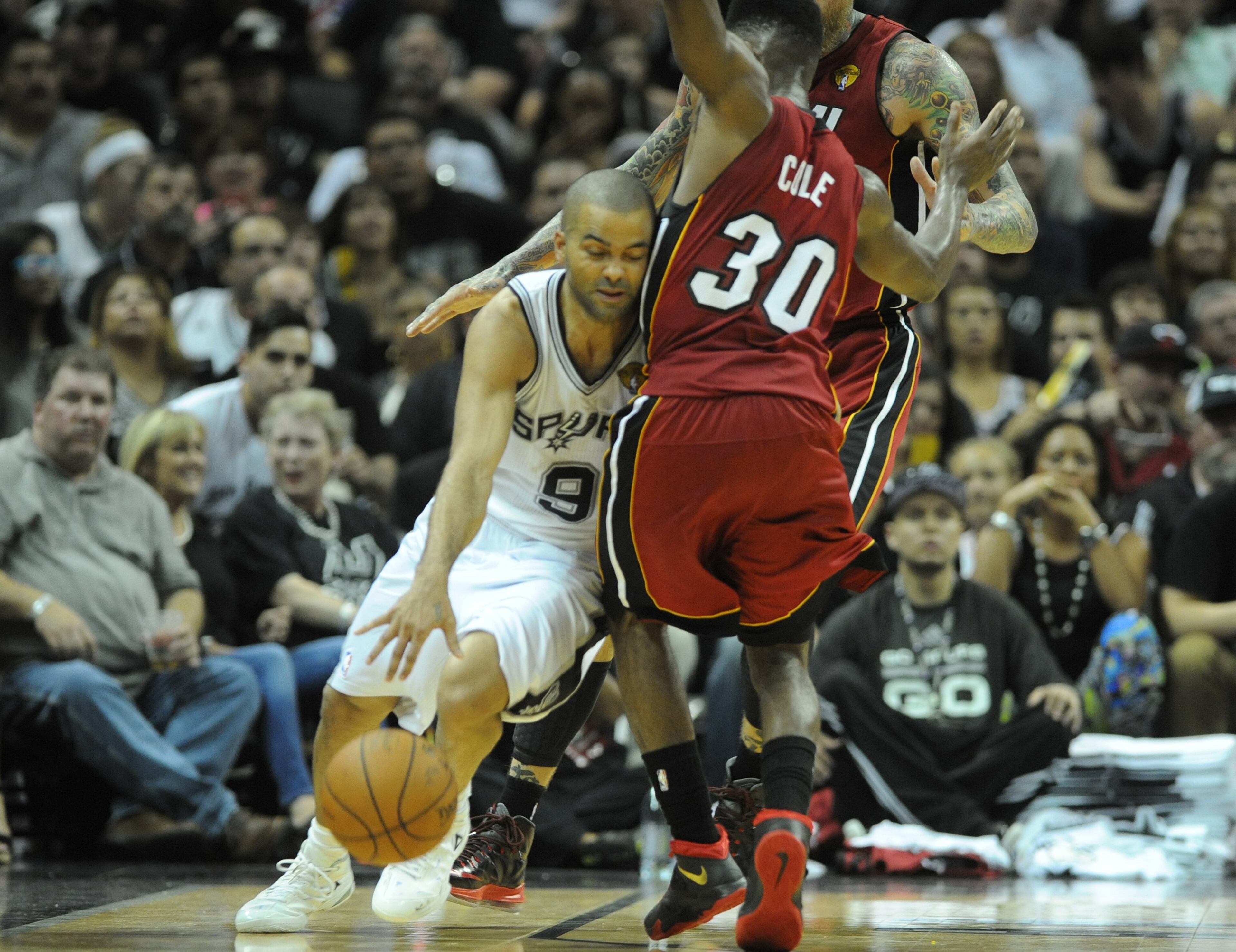 The San Antonio Spurs' Tony Parker (9) drives against the Miami Heat's Norris Cole in Game 1 of the NBA Finals on Thursday, June 5, 2014, at the AT&T Center in San Antonio. The Spurs won, 110-95. (Joe Cavaretta/Sun Sentinel/MCT)