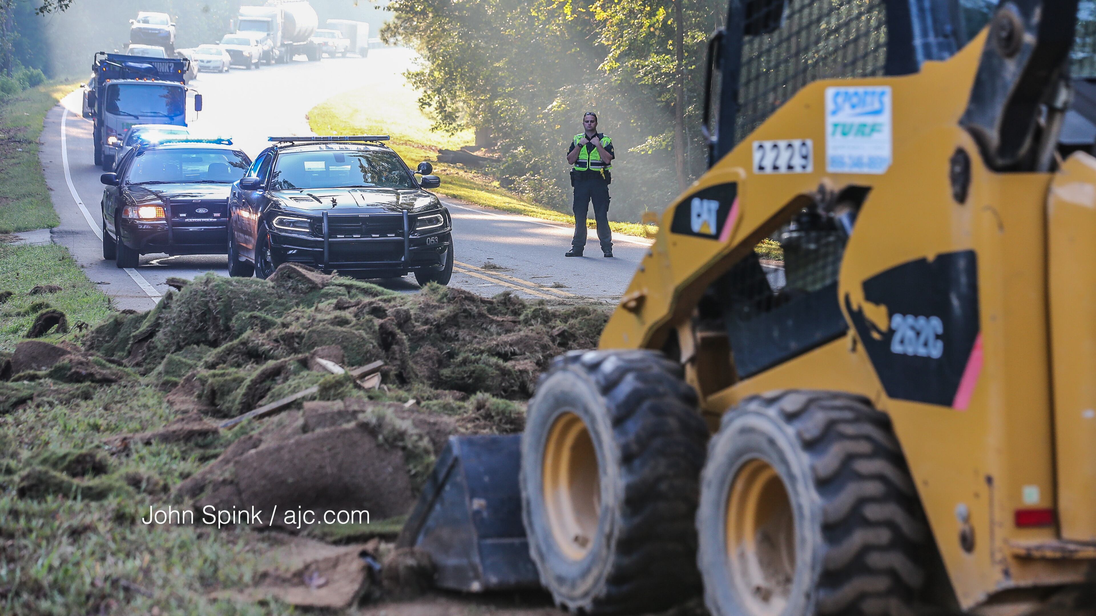 A truck lost an 8,000-pound load of sod, blocking a south Fulton County highway for hours early Wednesday. JOHN SPINK / JSPINK@AJC.COM