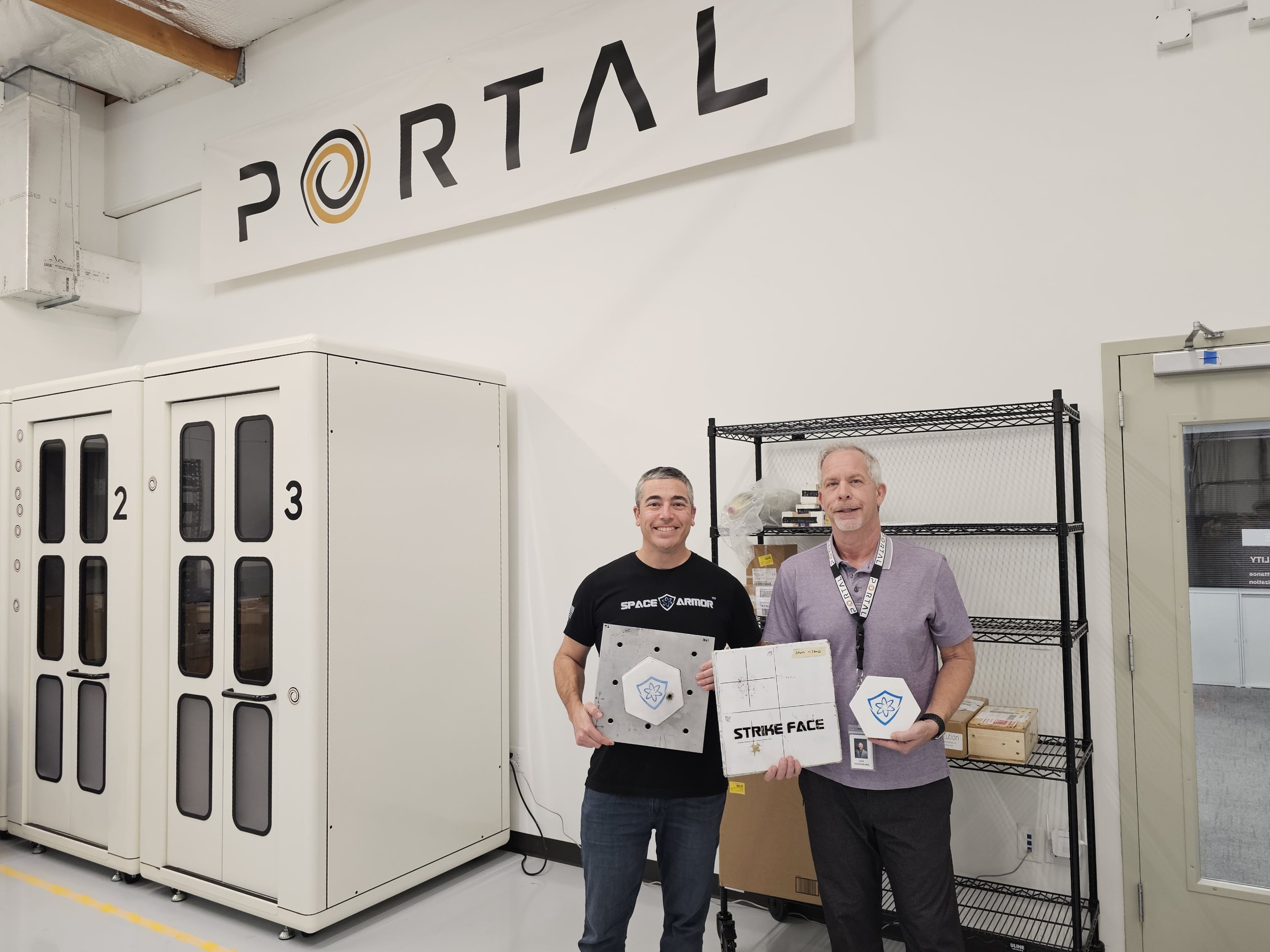 Atomic-6 CEO Trevor Smith and Portal Space Systems CEO Jeff Thornburg holding Space Armor tiles. (Courtesy of Atomic-6)