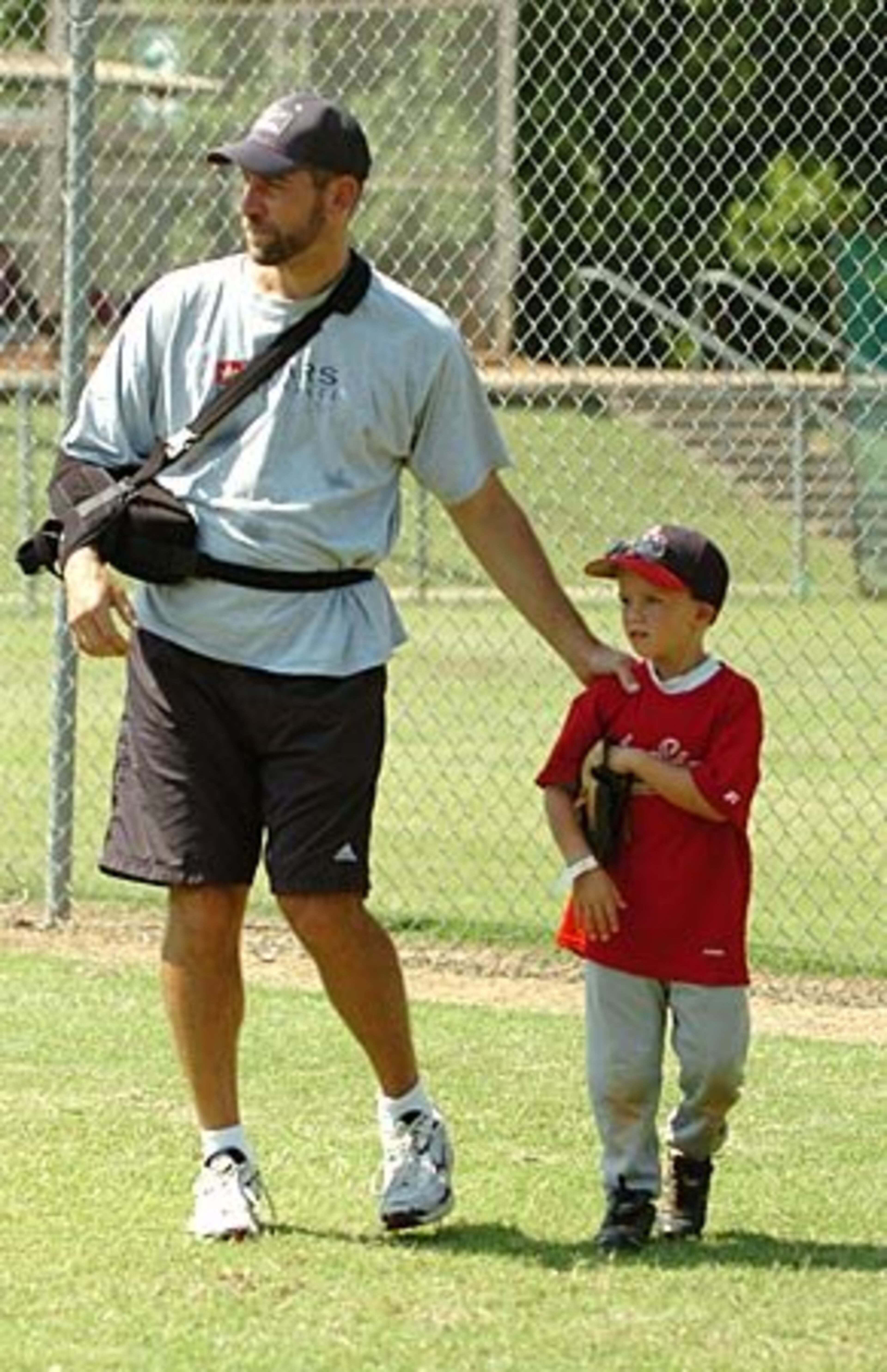 Good jog: Jake Witterman, 7, earns a pat on the back from Smoltz for giving it his all on the diamond. Smoltz understands the value of toughing it out (this is his fifth right arm surgery) and plans to return to the bigs if possible. "I realize at some point I'm going to have to say, 'This is it,.'" he says, adding "I don't know when that time would be."