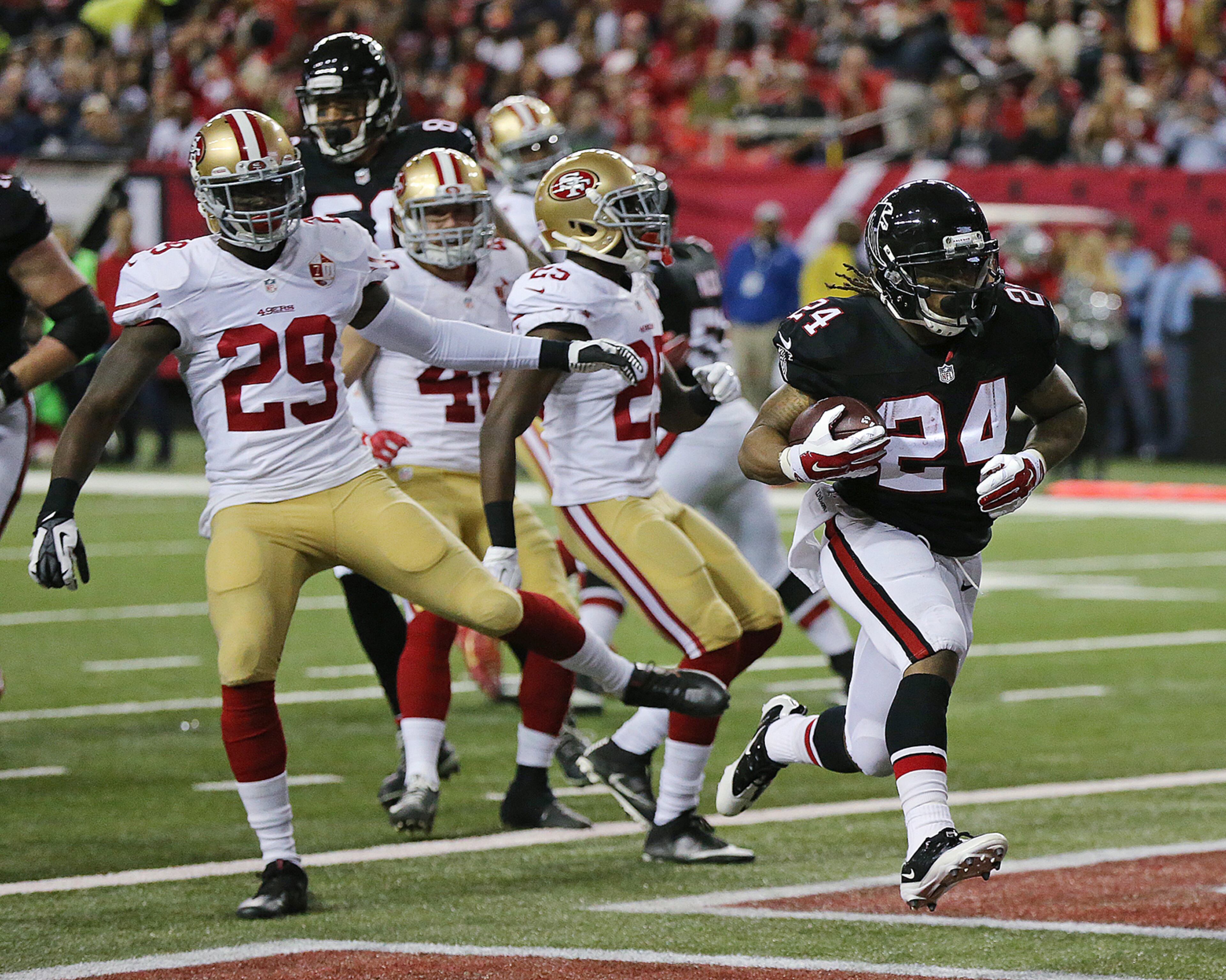 December 18, 2016, ATLANTA: Falcons running back Devonta Freeman gets past 49ers defenders for a touchdown and a 7-0 lead during the first quarter in an NFL football game on Sunday, Dec. 18, 2016, in Atlanta. It was FreemanÛªs first of three touchdowns. Curtis Compton/ccompton@ajc.com