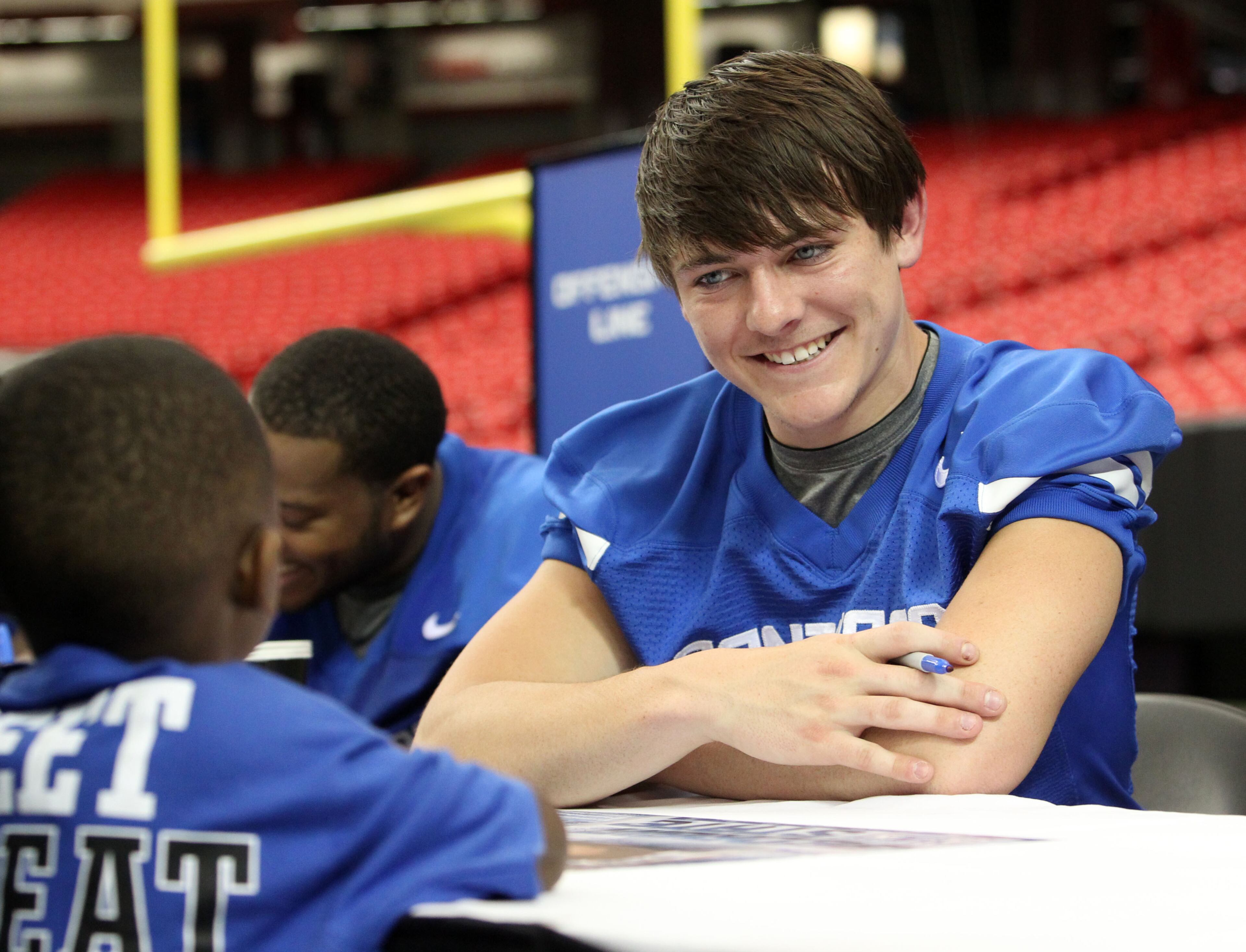 Georgia State quarterback Clay Chastain (11) talks with a young fan while signing autographs after the scrimmage.