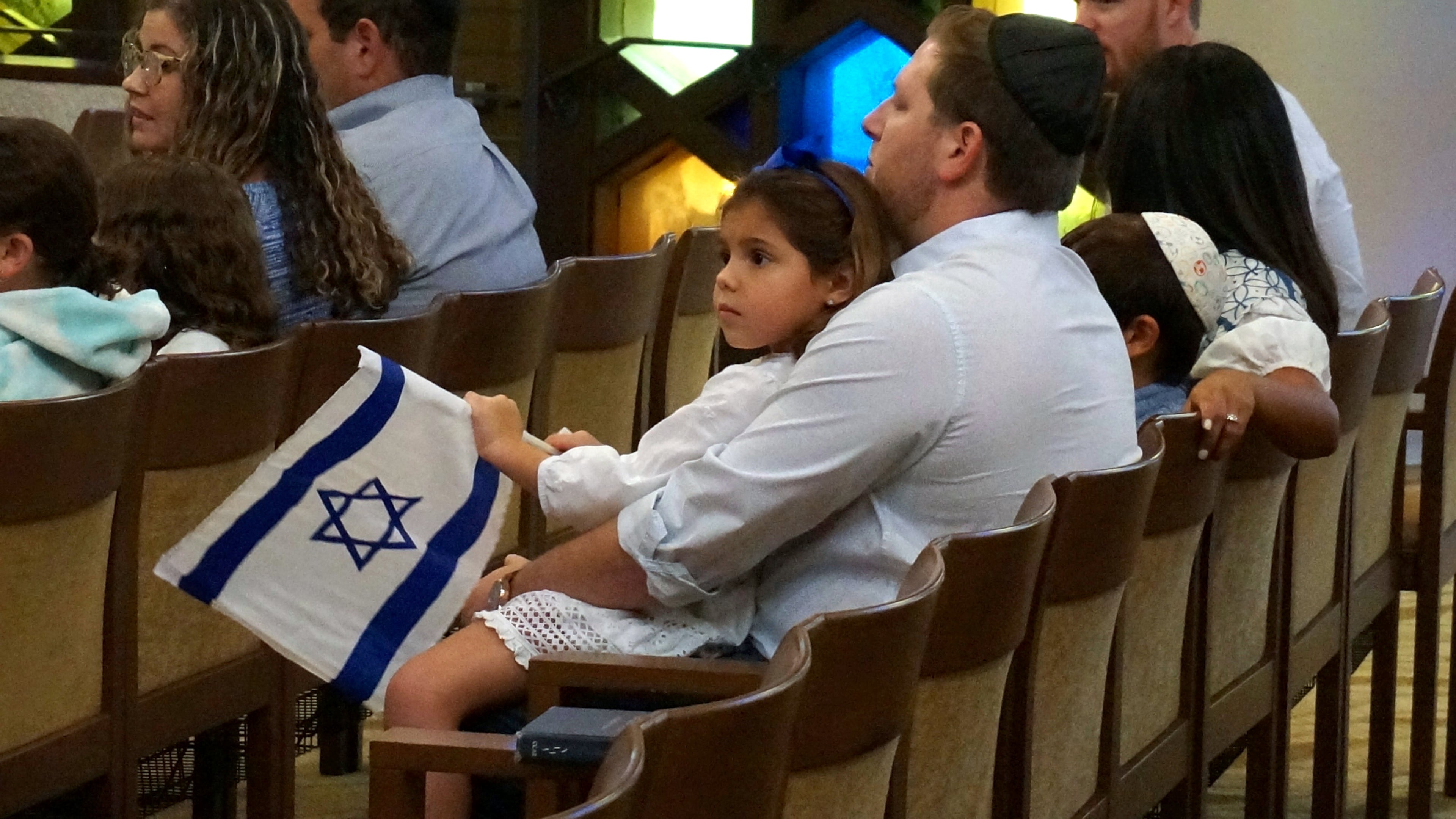FILE - A family with Israel flags attends Shabbat services at Temple Beth Sholom in Miami Beach, Fla., Oct. 13, 2023. (AP Photo/Giovanna Dell'Orto, File)