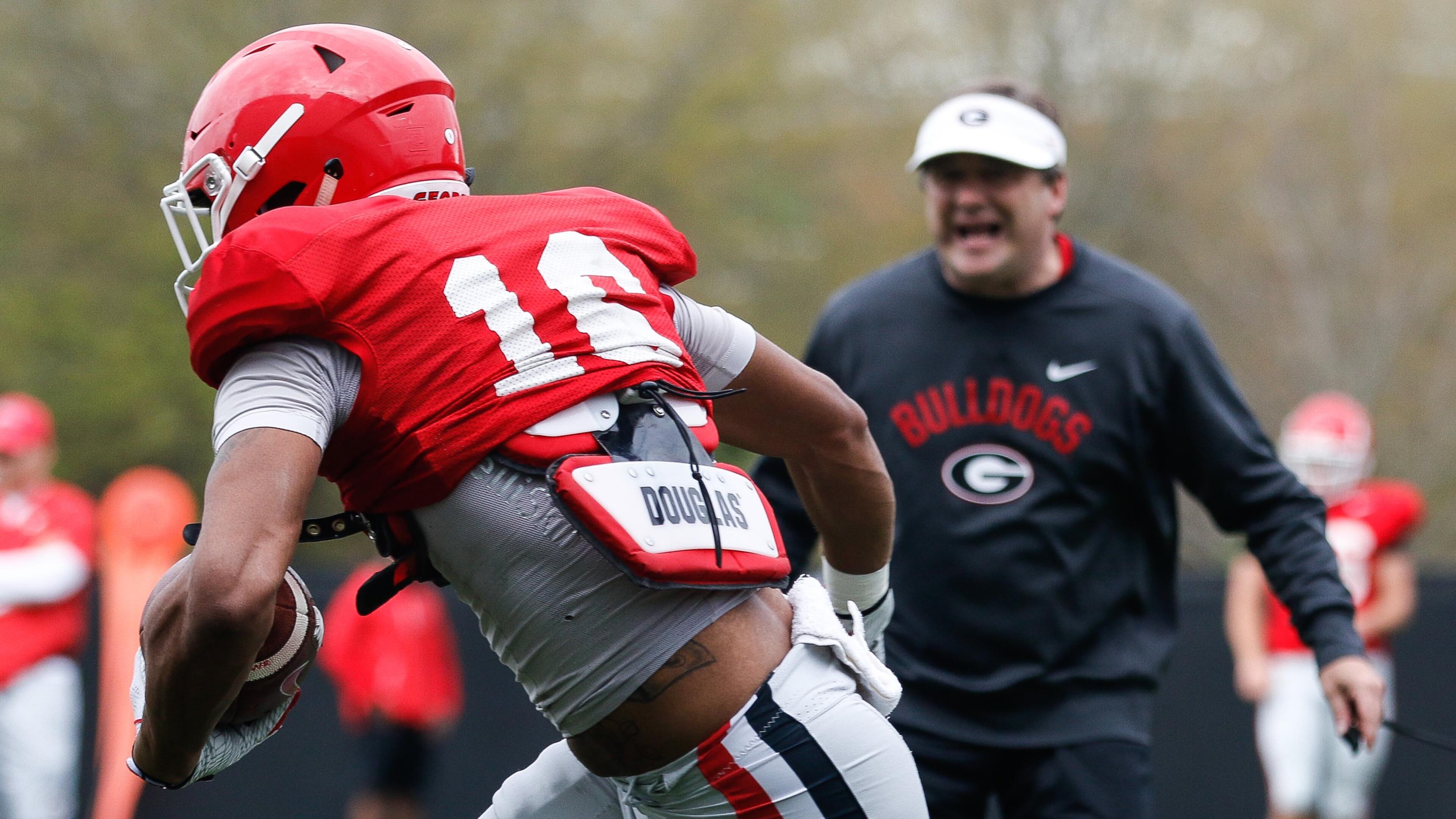 With head coach Kirby Smart watching intently (background), Georgia wide receiver Demetris Robertson (16) hustles during an offensive drill at spring practice Tuesday, March 28, 2019, on the Woodruff Practice Fields in Athens.