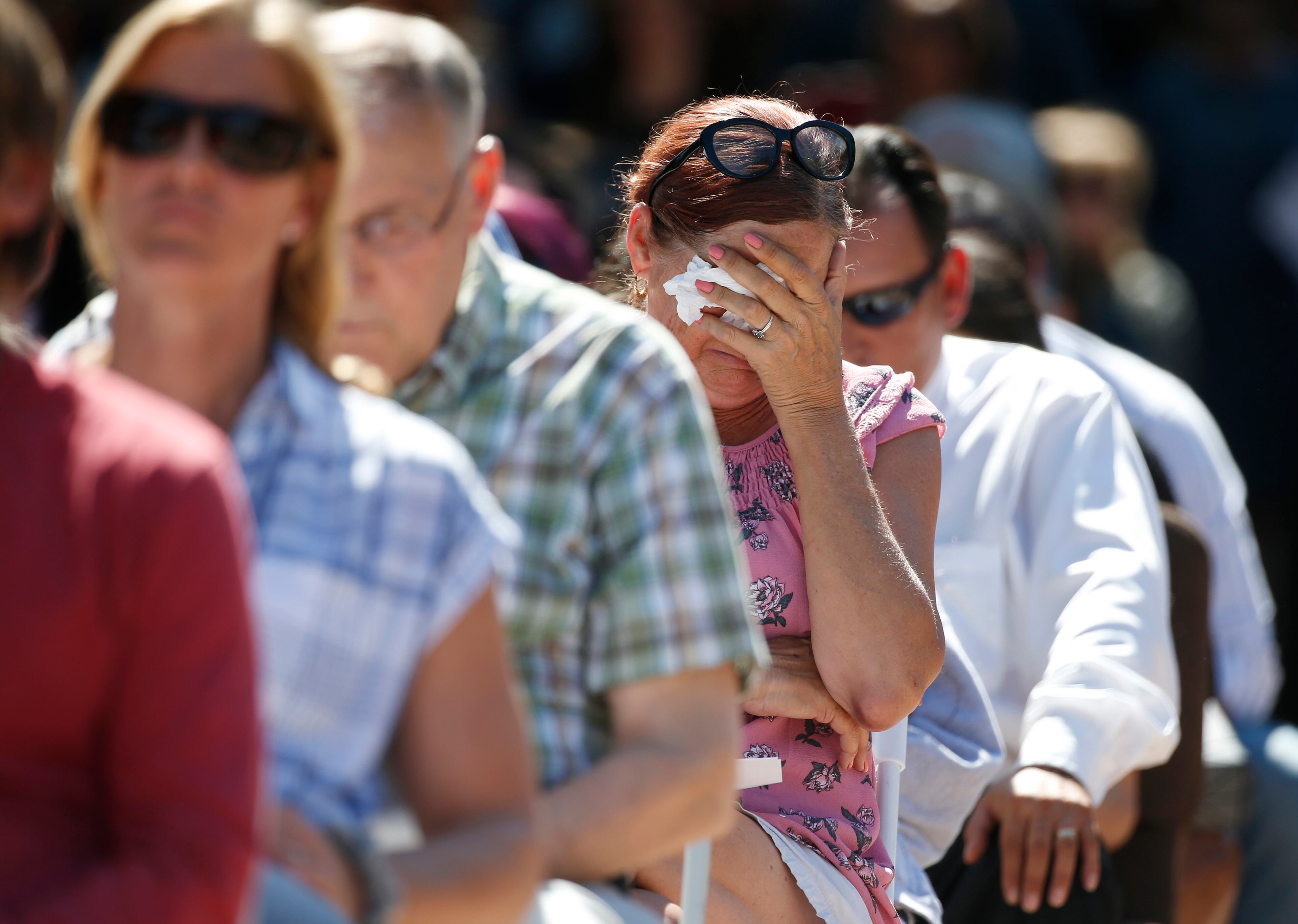 Attendees react at a prayer vigil for the victims of the shooting at Marjory Stoneman Douglas High School at the Parkland Baptist Church, Thursday, Feb. 15, 2018 in Parkland, Fla. Nikolas Cruz, a former student, was charged with 17 counts of premeditated murder Thursday morning. (AP Photo/Wilfredo Lee)