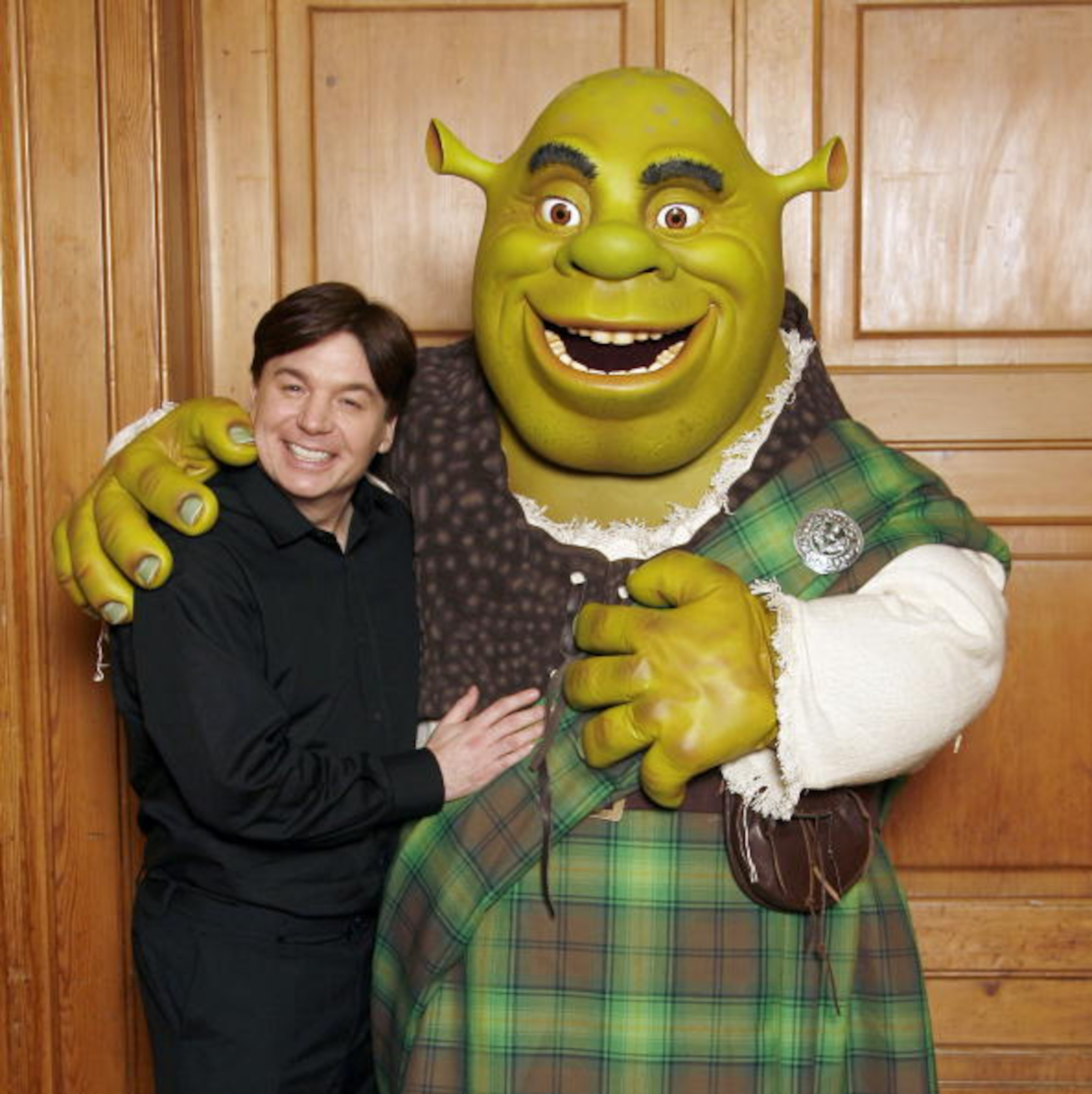 LONDON - JUNE 11 : (UK TABLOID NEWSPAPERS OUT) Mike Myers poses alongside Shrek after Shrek received official Scottish clan tartan at The Dorchester Hotel on June 11, 2007 in London, England. The tartan was specially woven in 'Shrek Green' design using traditional methods by kilt manufacturers Lochcarron. (Photo by Gareth Davies/Getty Images)
