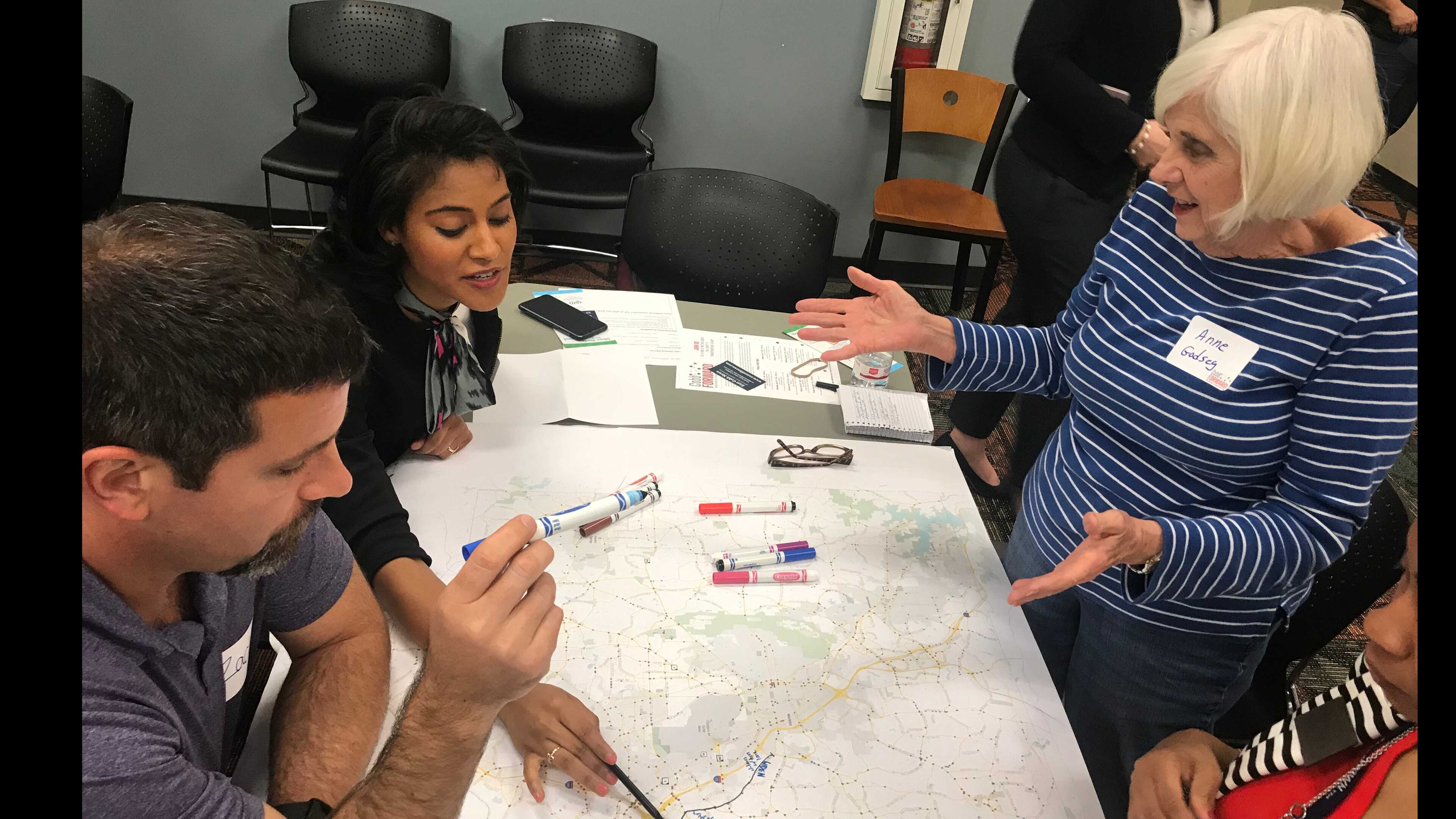 Left to right: Residents Zach Johnson, Jerica Richardson and Anne Godsey commiserate over traffic in East Cobb while highlighting the worst sections on a map for Cobb DOT. (Meris Lutz/AJC)